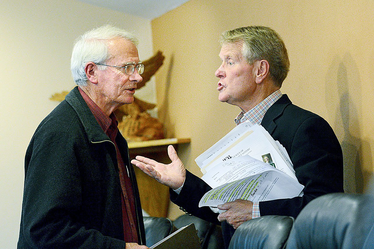 Clallam County District 2 commissioner candidates Ron Richards, left, a Port Angeles Democrat, and Randy Johnson of Port Angeles, who filed with no party preference, talk after the League of Women Voters forum in Port Angeles on Tuesday night. (Jesse Major/Peninsula Daily News)