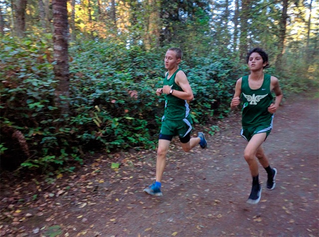 Rodger Johnson                                Port Angeles Sophomores AJ Fischer and Aron Trubow work together through the second mile of their cross country race at Robin Hill County Park.