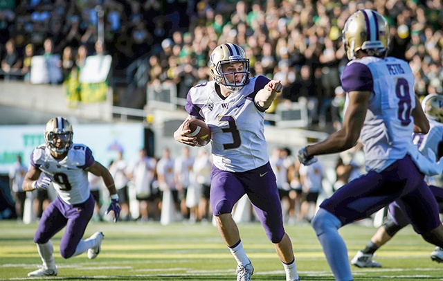 The Associated Press                                Washington quarterback Jake Browning (3) points upfield during the Huskies 70-21 win over Oregon. Browning had eight total touchdowns, six passing, two rushing.