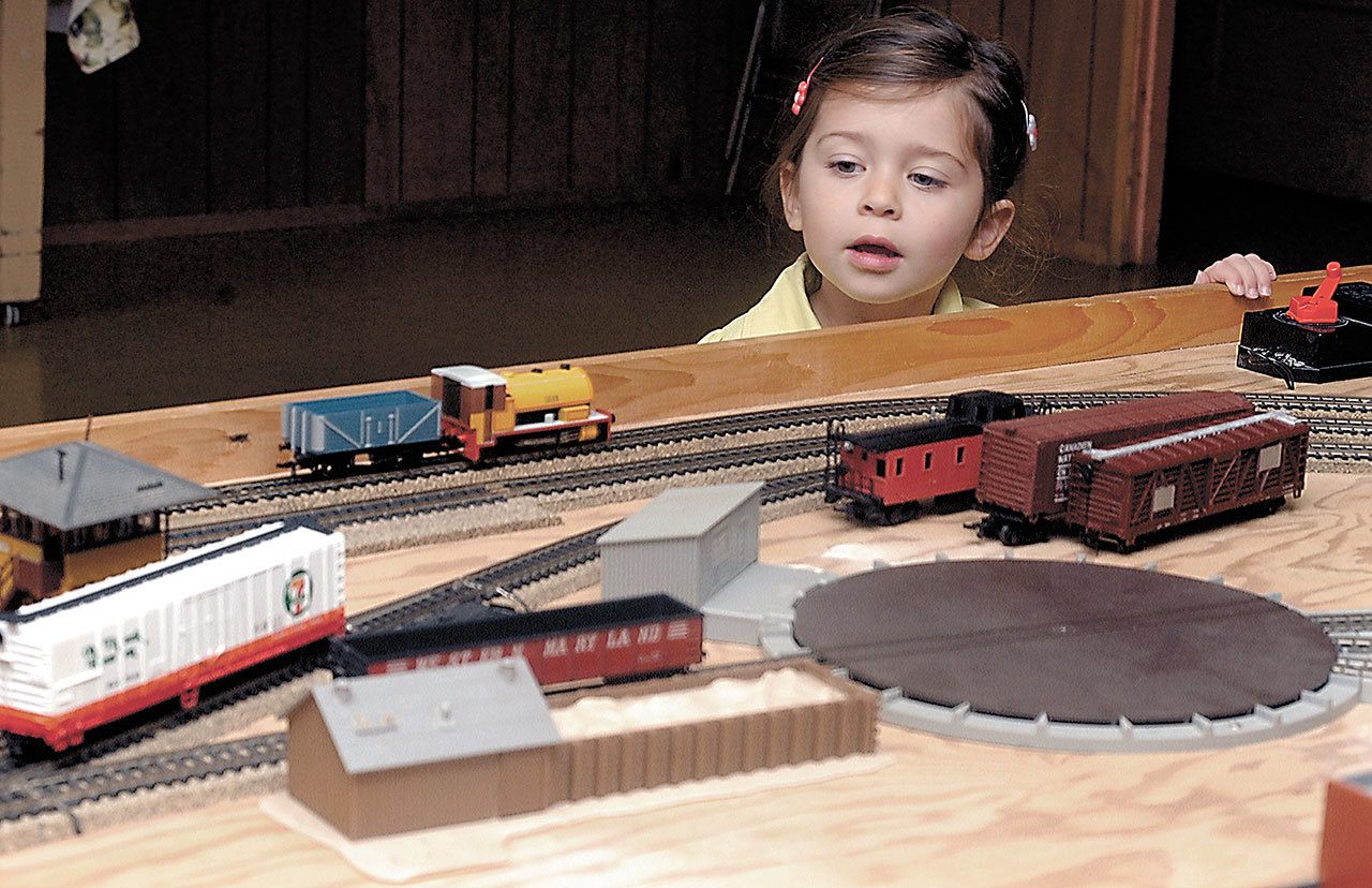 Three-year-old Harper Hilliker of Sequim examines a model train display during a model train show and swap at the Sequim Prairie Grange hall west of Sequim in 2015. The event, hosted by the North Olympic Railroaders, will feature several model train setups and a variety of vendors with items for sale or trade. (Keith Thorpe/Peninsula Daily News)
