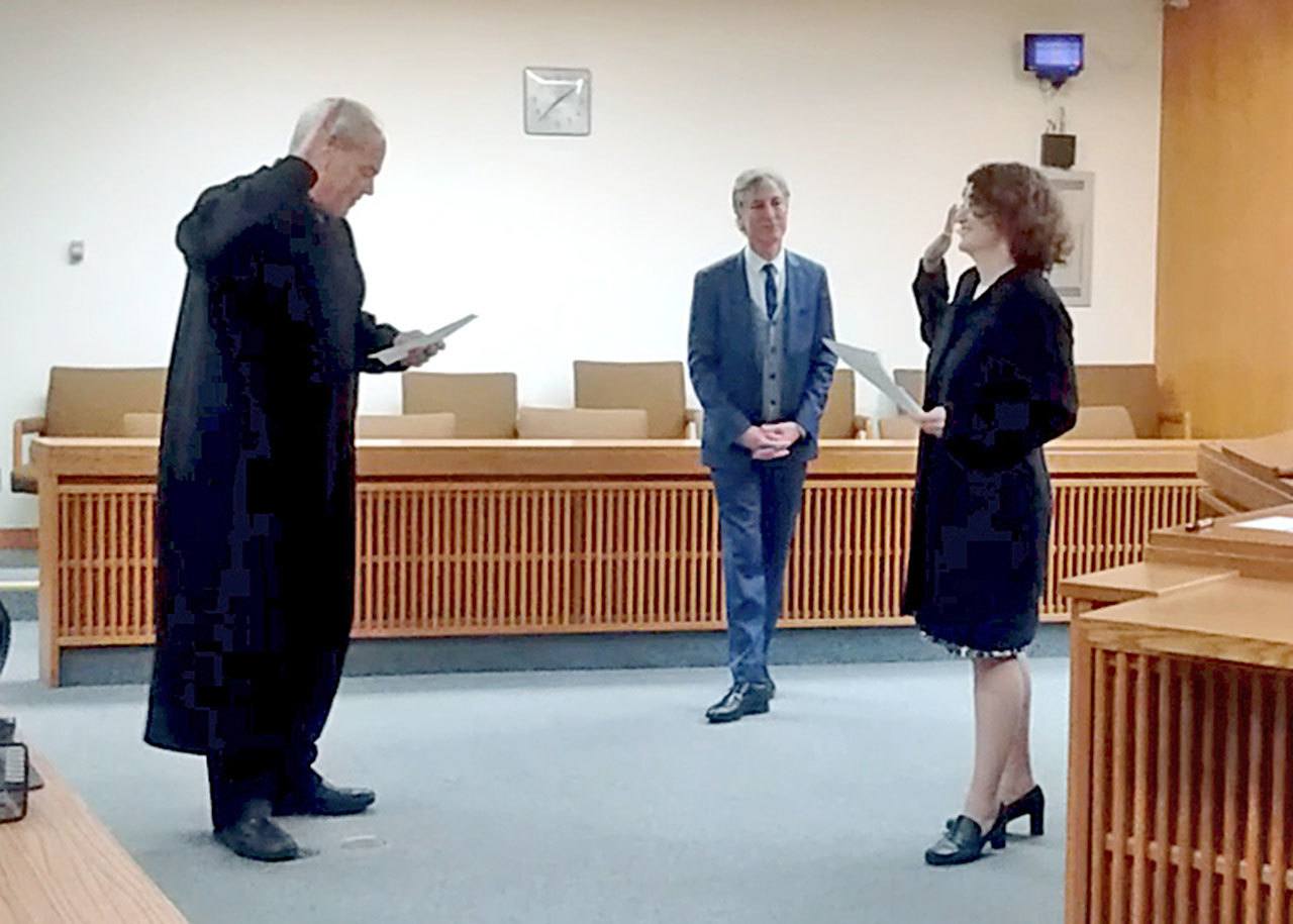 Vanessa Ridgway, right, is sworn in to the Washington State Bar Association as a limited-license legal technician by Clallam County Superior Court Judge Eric Rohrer, left. She is the first LLLT on the North Olympic Peninsula. At center is attorney Mark Baumann. (Vanessa Ridgway)