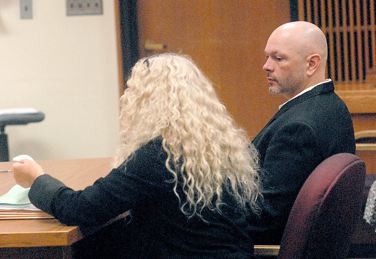 Adam Chamberlin, right, sits with attorney Karen Unger in Clallam County Superior Court on Tuesday in Port Angeles. (Keith Thorpe/Peninsula Daily News)
