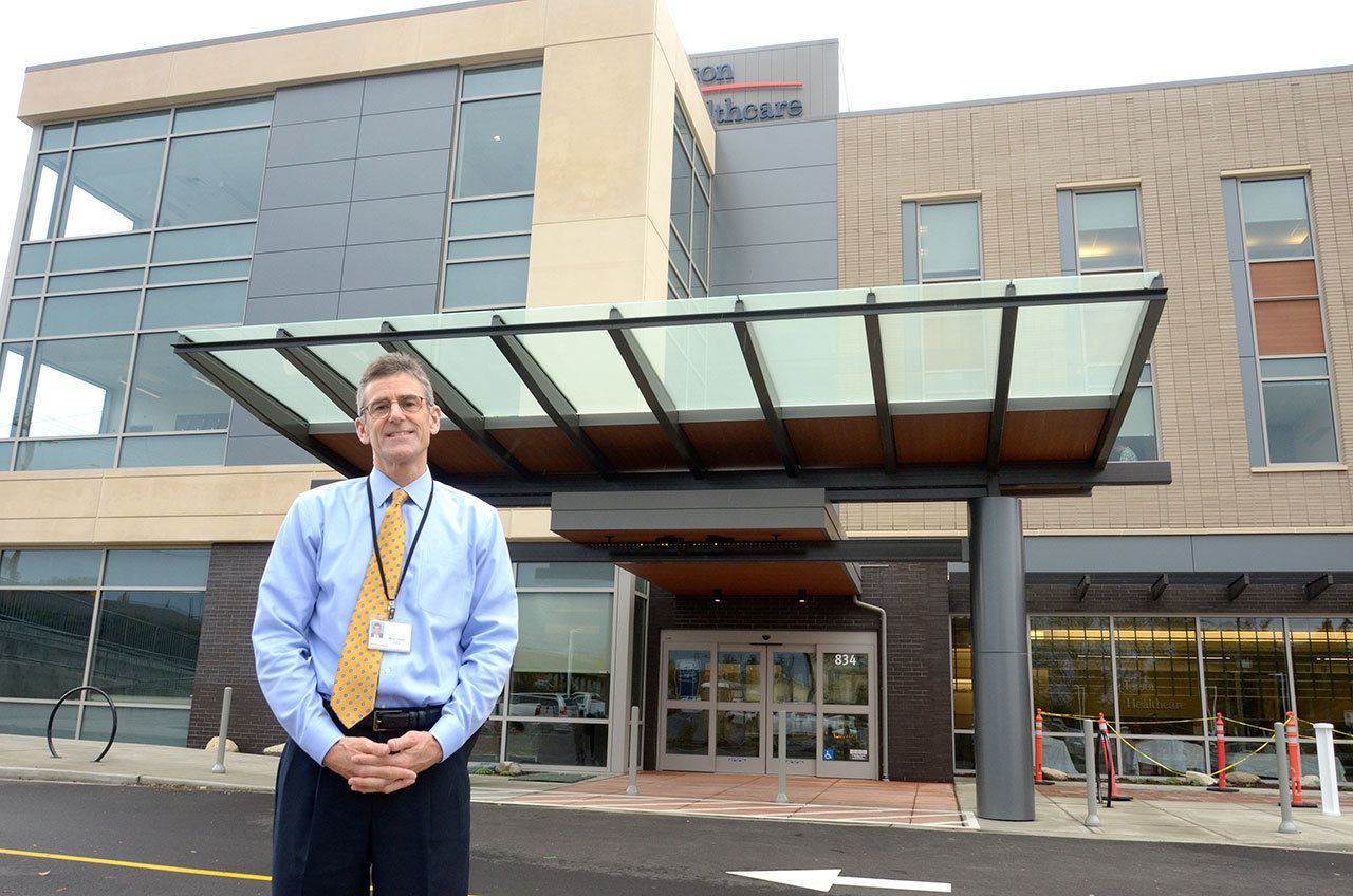 Jefferson Healthcare CEO Mike Glenn stands in front of the hospital’s new building, which will open officially Monday after a ribbon-cutting Sunday. (Cydney McFarland/Peninsula Daily News)