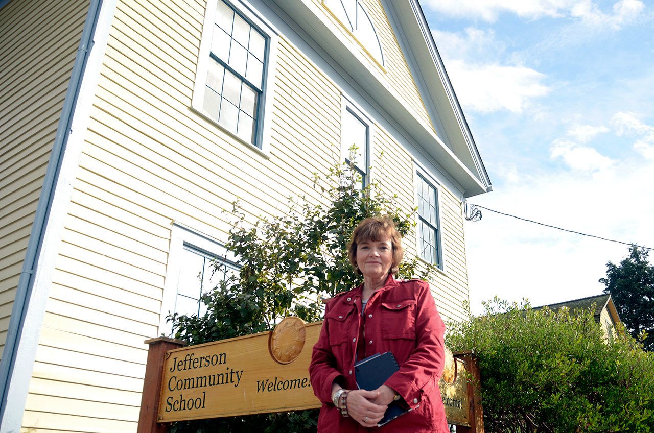 Port Townsend Main Street Program Director Mari Mullen stands in front of Jefferson Community School, one of the buildings that has benefited from a HUD historic preservation loan. (Cydney McFarland/Peninsula Daily News)