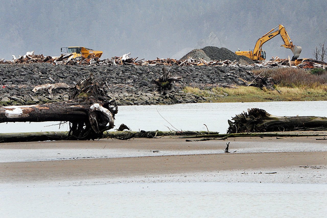 Construction crews work to rebuild the Rialto Beach jetty as seen from across the Quillayute River from LaPush. (Lonnie Archibald)