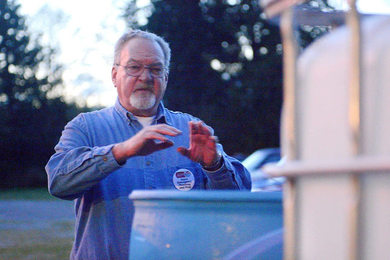 Terry Barnett, Joyce Emergency Planning and Preparation volunteer, talks about the water purification system he made, which would be used to make potable water during an emergency. (Jesse Major/Peninsula Daily News)