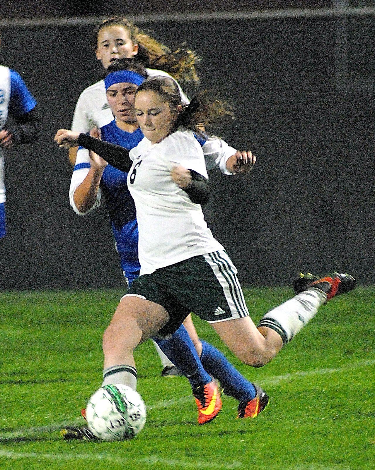 Keith Thorpe/Peninsula Daily News Port Angeles’ Emily Boyd, front, slips past the defense of North Mason’s Abby Leibold as teammate Delany Wenzel, back, looks on at Civic Field in Port Angeles.