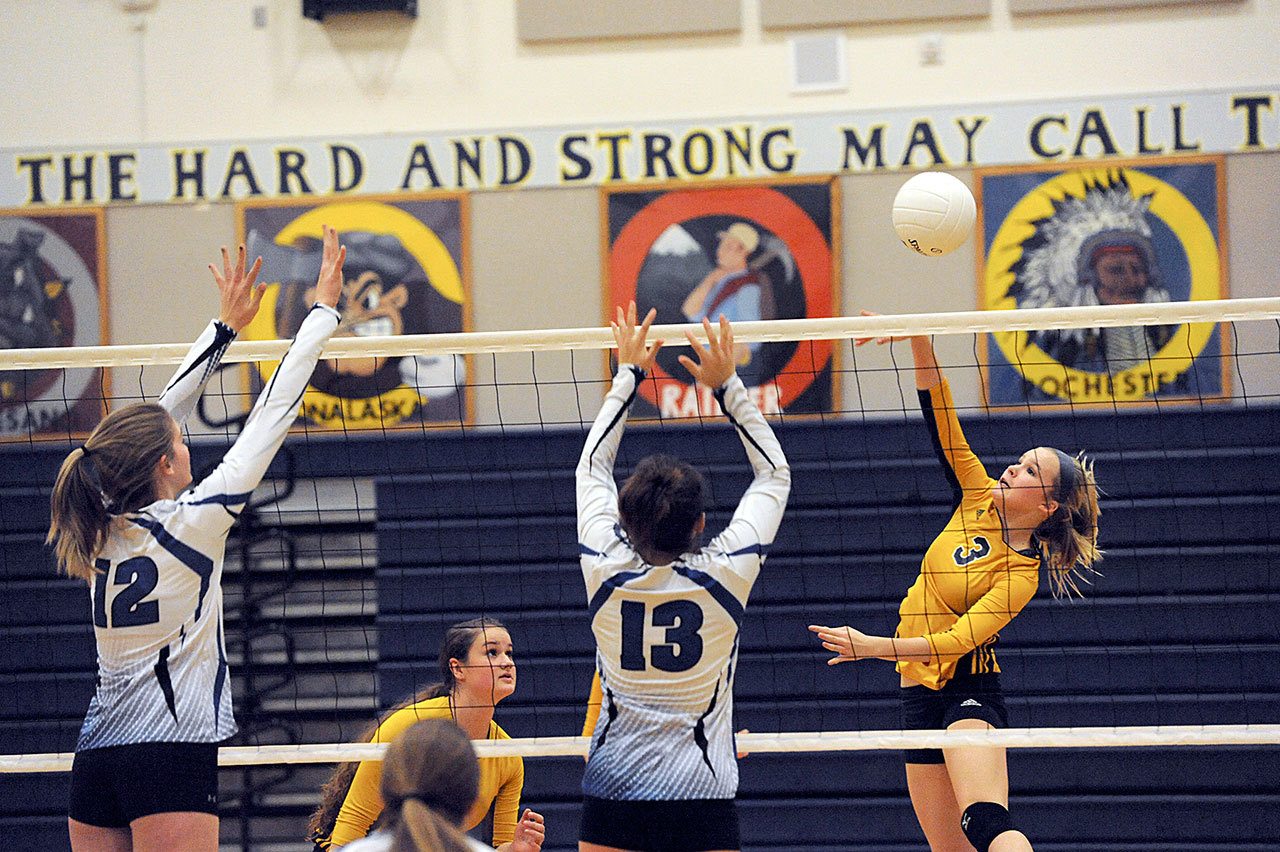 Lonnie Archibald/for Peninsula Daily News                                Forks freshman Jayden Olson hits against Elma&rsquo;s Jalyn Sackrider (12) and Kali Rambo (13) during the Spartans&rsquo; three-set sweep of the Eagles.