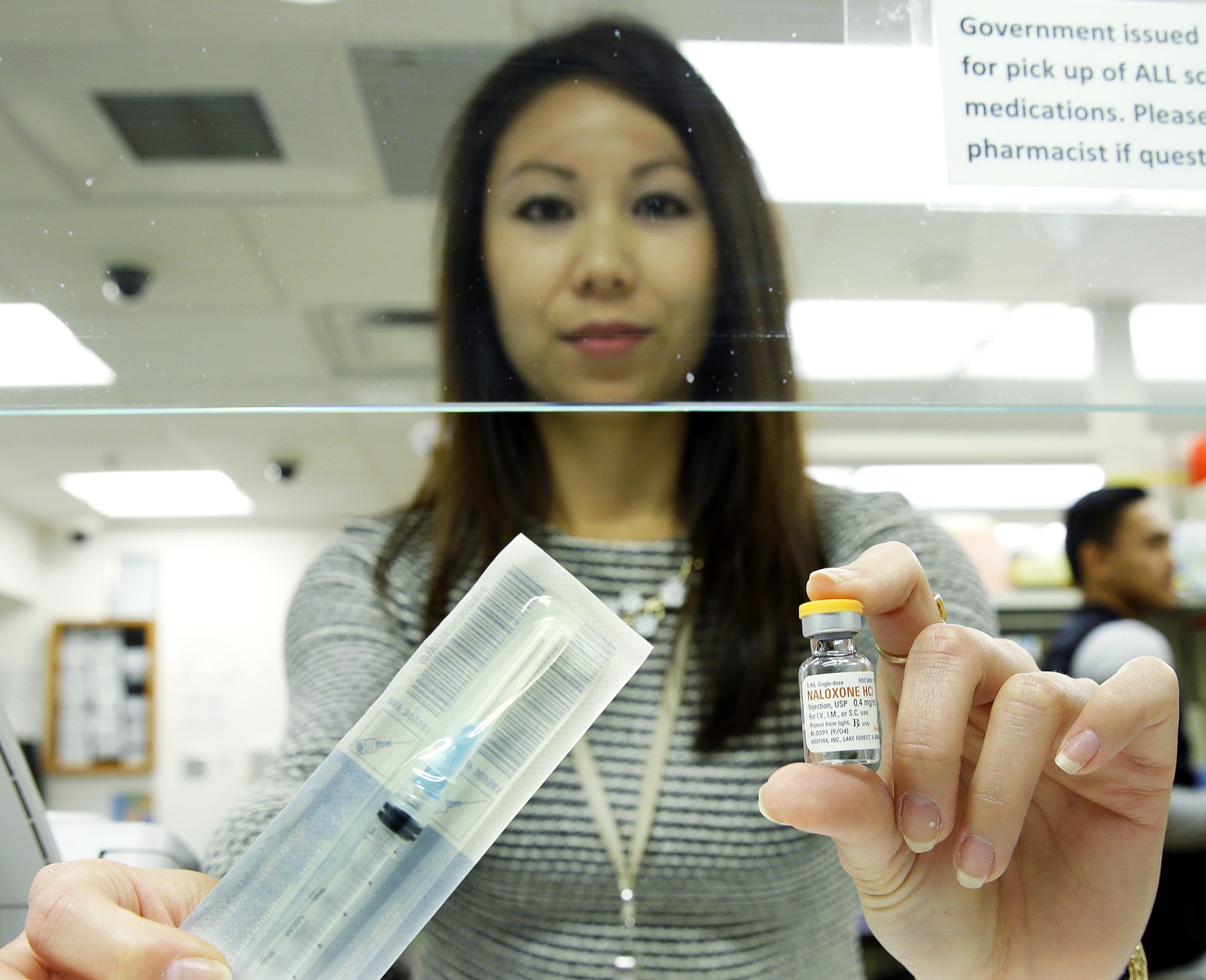 Tess Nishida, a pain pharmacist at the University of Washington, poses for a photo Friday holding a vial of Naloxone, which can be used to block the potentially fatal effects of an opioid overdose, at an outpatient pharmacy at the university. (Ted S. Warren/The Associated Press)
