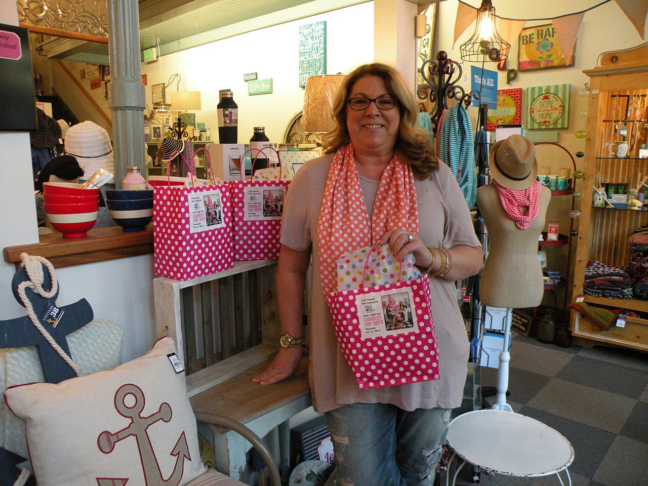 Marci Spittler of Tickled Pink shows off the polka dot theme for Port Townsend Main Street’s Girls’ Night Out. Tickled Pink donated 500 polka dot scarves for this year’s goodie bags. (Mari Mullen)
