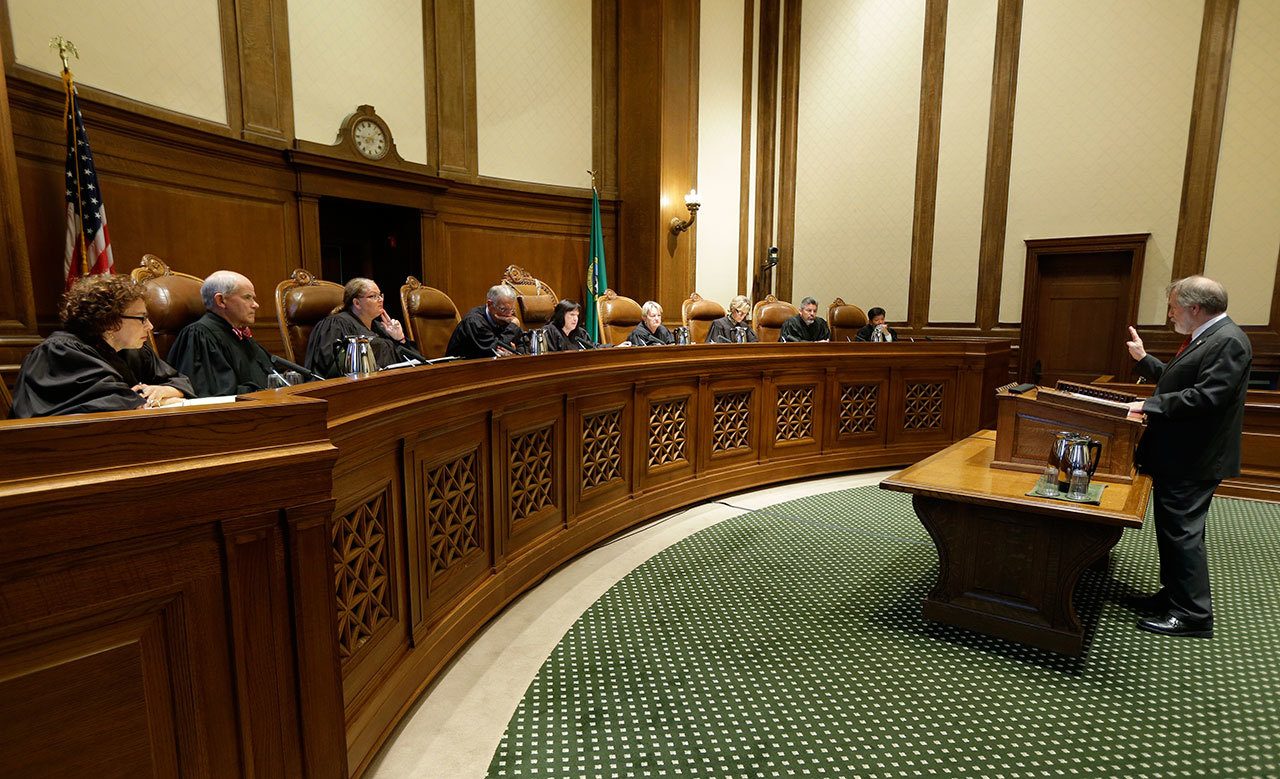 Alan Copsey, right, a deputy attorney general for the state of Washington, speaks during a Sept. 7 hearing before the state Supreme Court on a lawsuit against the state over education funding in Olympia. (Ted S. Warren/The Associated Press)