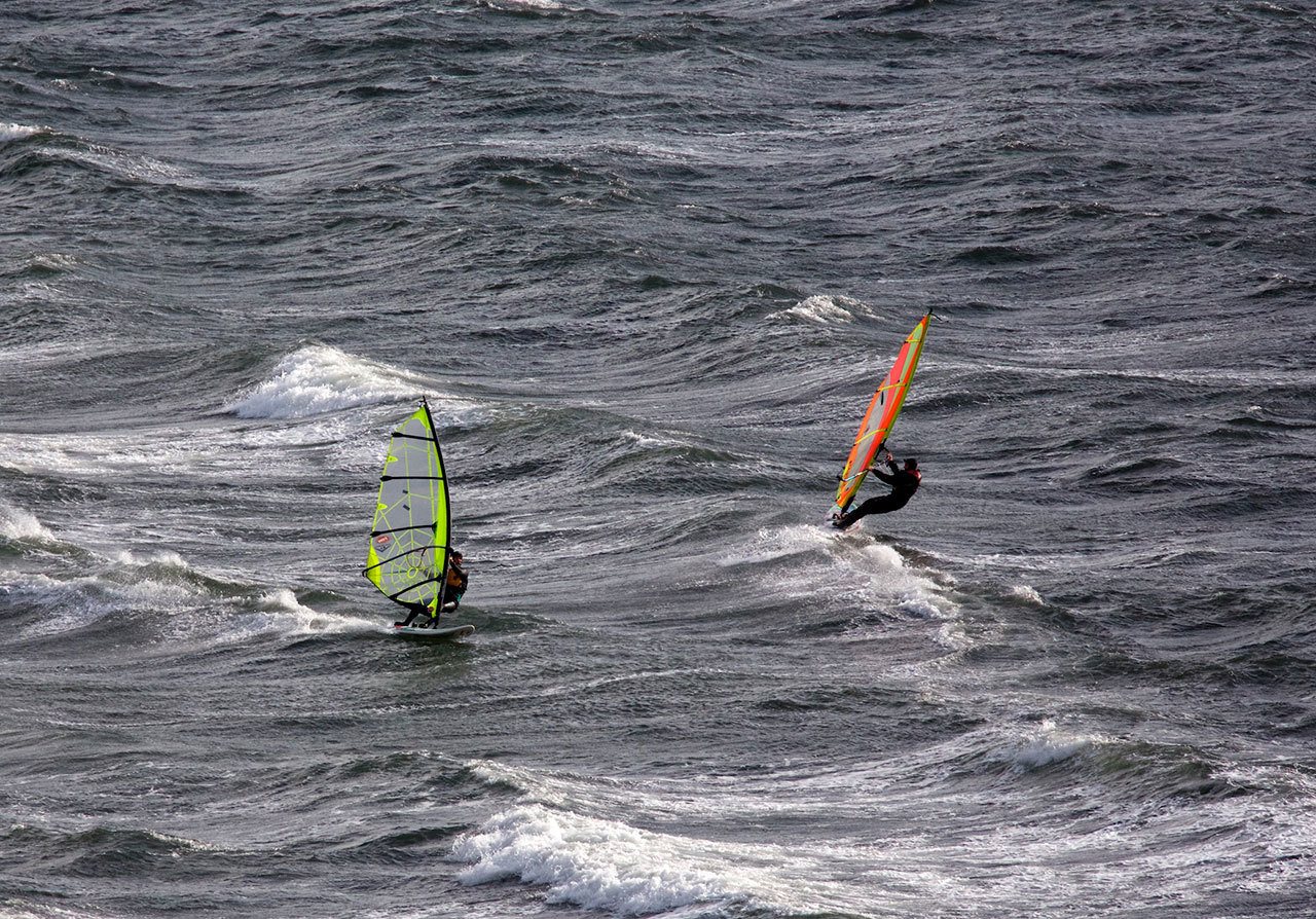 A pair of windsurfers take advantage of the brisk winds blowing across Port Townsend on Sunday to enjoy their sport. (Steve Mullensky/for Peninsula Daily News)