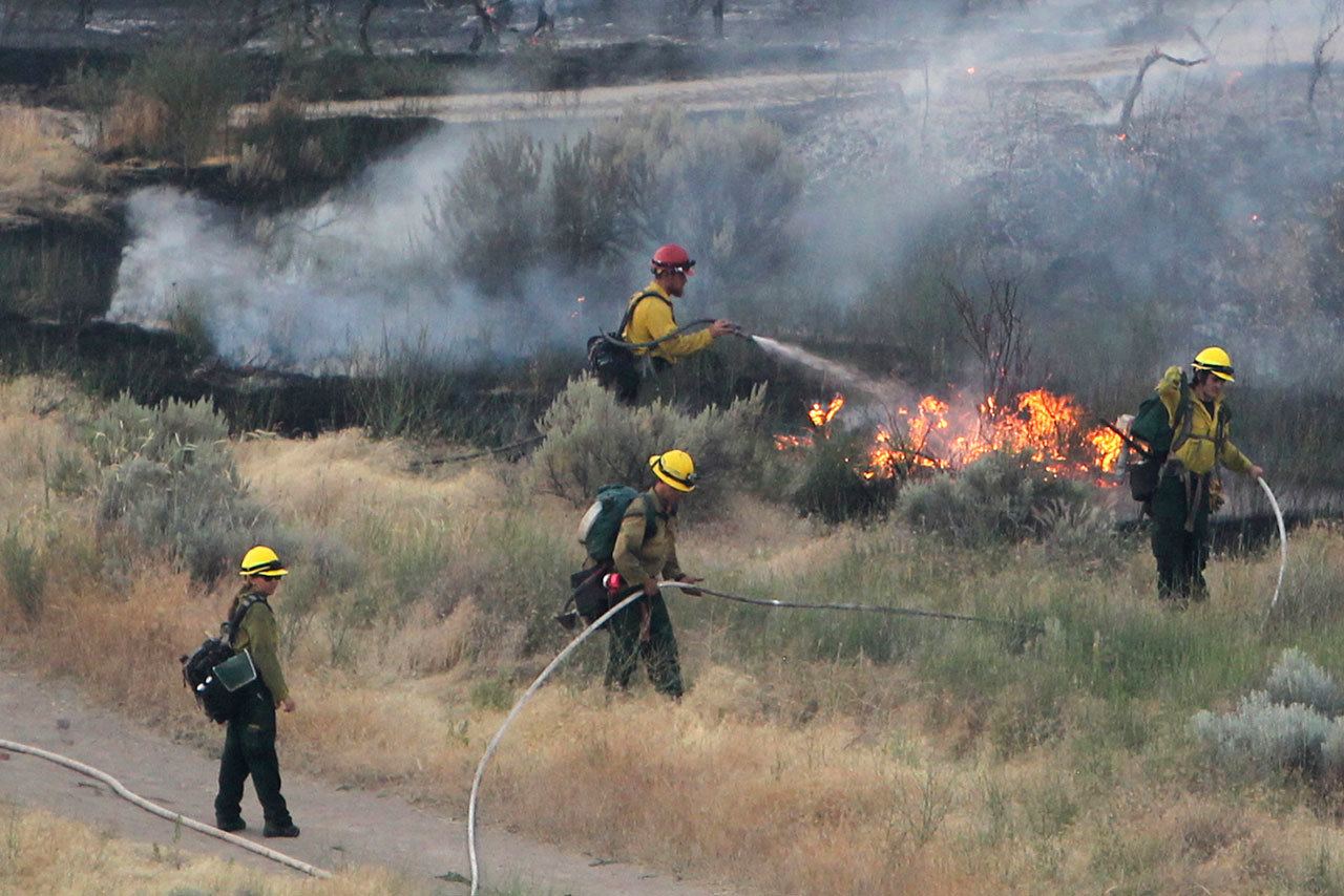 Firefighters respond to a wildfire near the Morningside Heights neighborhood near Table Rock in east Boise, Idaho, on June 30. (Joe Jaszewski/Idaho Statesman via AP)