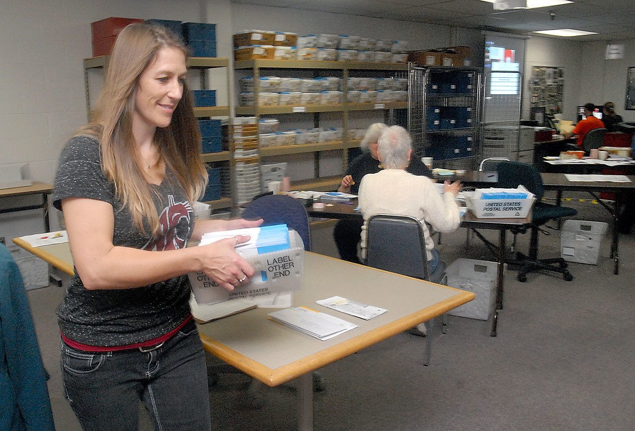 Clallam County Auditor Shoona Riggs carries a mailing tray of ballots at the county’s elections center Saturday at the county courthouse in Port Angeles. (Keith Thorpe/Peninsula Daily News)