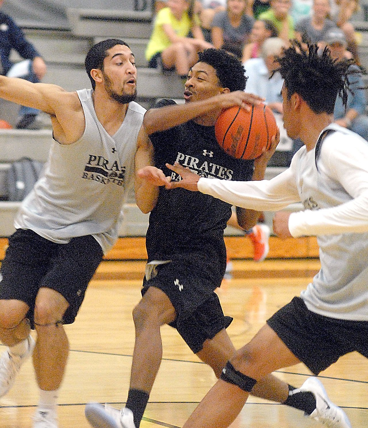 Keith Thorpe/Peninsula Daily News Peninsula College mens team players, from left, Jarod Felix, Elijah Williams and Zach Day, take part in an intrasquad scrimmage on Friday night on their home court in Port Angeles.