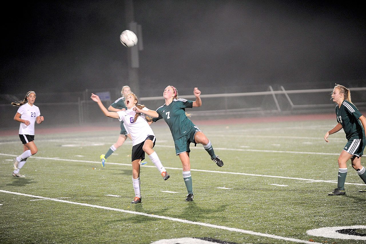 Matthew Nash/Olympic Peninsula News Group                                Sequim&rsquo;s Jessica Dietzman and Port Angeles&rsquo; Kyrsten McGuffey jump for a loose ball during a West Central District tournament soccer match. The Roughriders won in penalty kicks to clinch their first state appearance in 30 years.