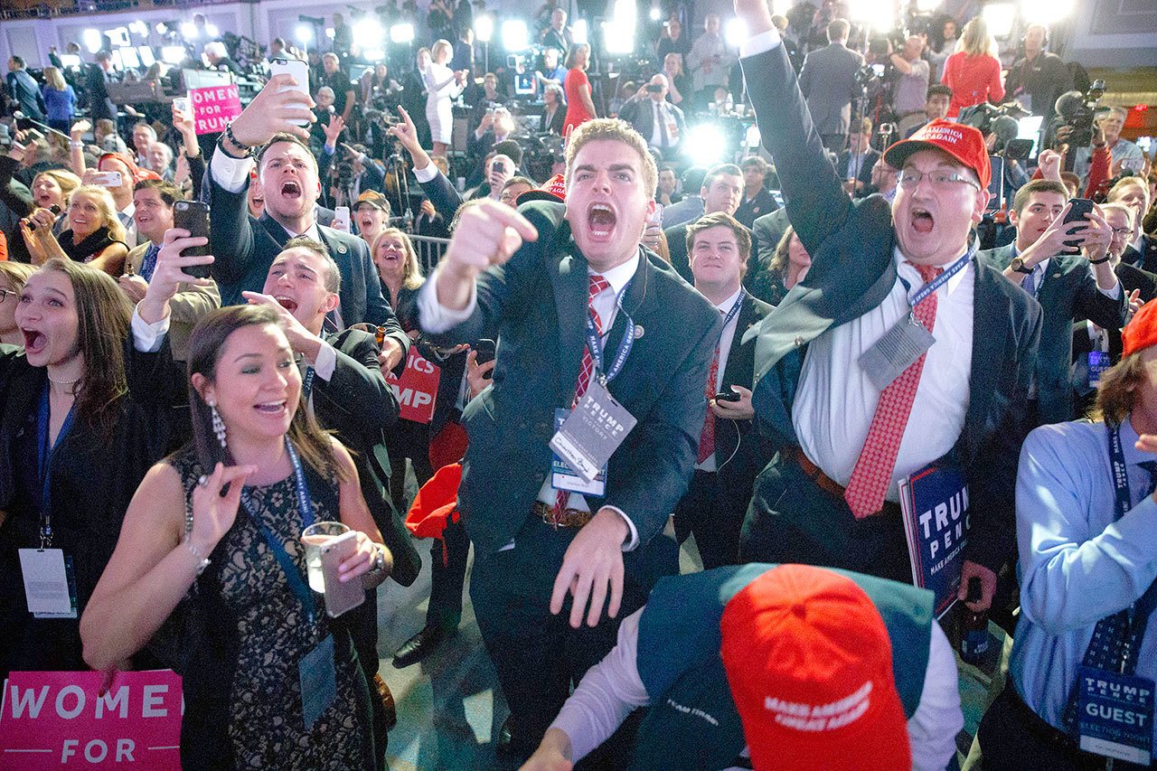 Supporters of Republican presidential candidate Donald Trump cheer as they watch election returns during a rally Tuesday in New York City. (The Associated Press)