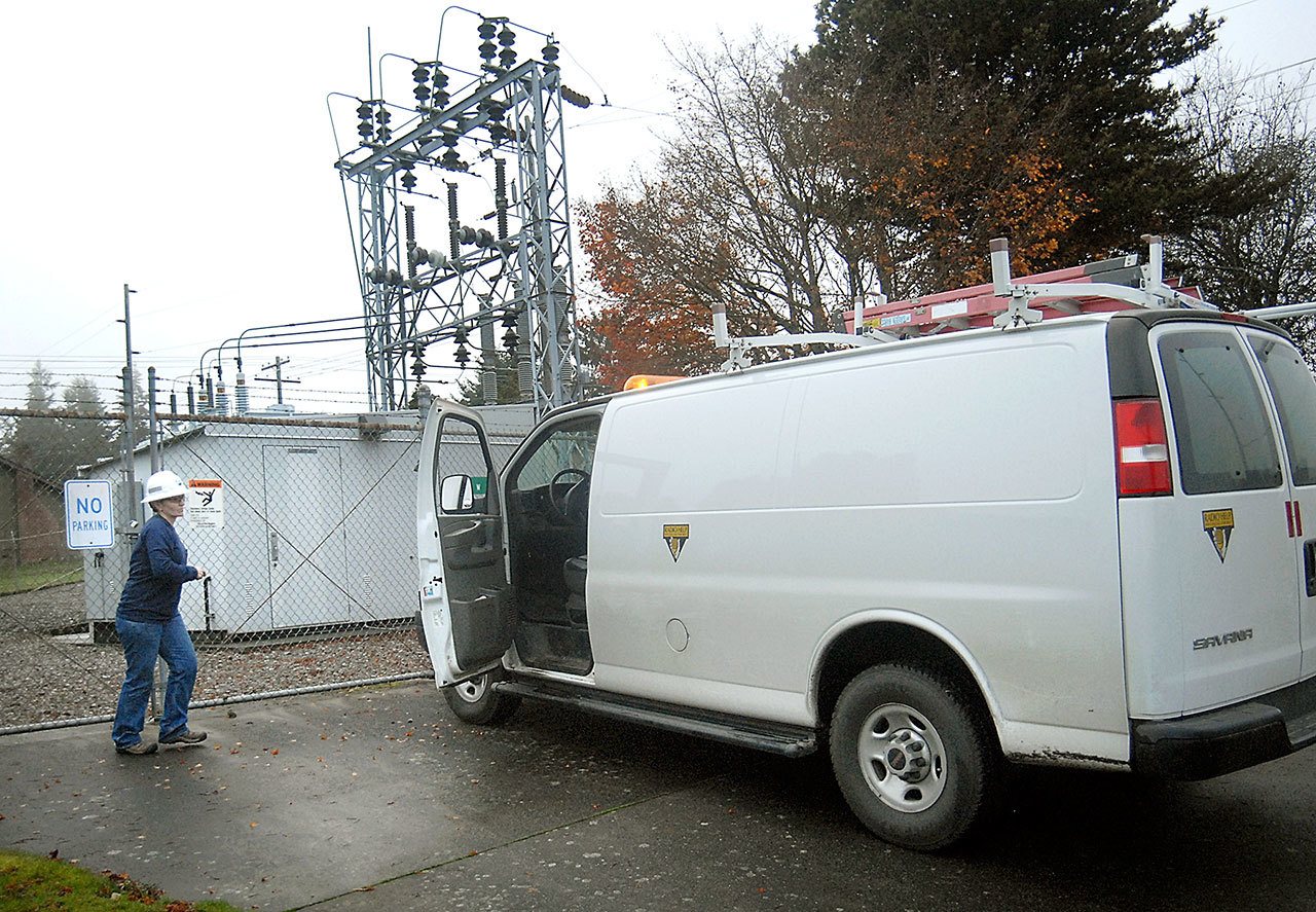 Lisa Hainstock, a relay technician for the Port Angeles Public Works Department, emerges from the I Street substation after restoring power to the west side of the city, the result of a problem with a transmission line. (Keith Thorpe/Peninsula Daily News)