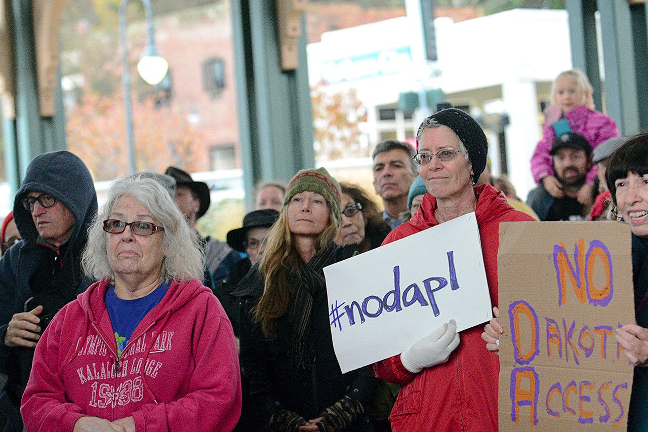 Supporters of the Standing Rock Sioux Tribe’s opposition to the Dakota Access Pipeline listen as members of the Lower Elwha Klallam Tribe sing during a protest of the pipeline in downtown Port Angeles on Tuesday. (Jesse Major/Peninsula Daily News)