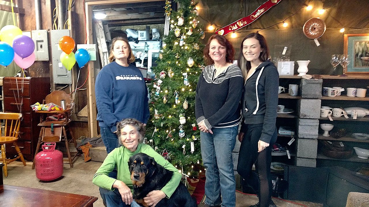 Standing from left are Jennifer Pelikan, Cheri Tinker and Anastasia Rigby, all of Sarge’s Attic. Seated is Betsy Cadwell with her pup, Buster, the unofficial greeter and mascot of Sarge’s Attic.