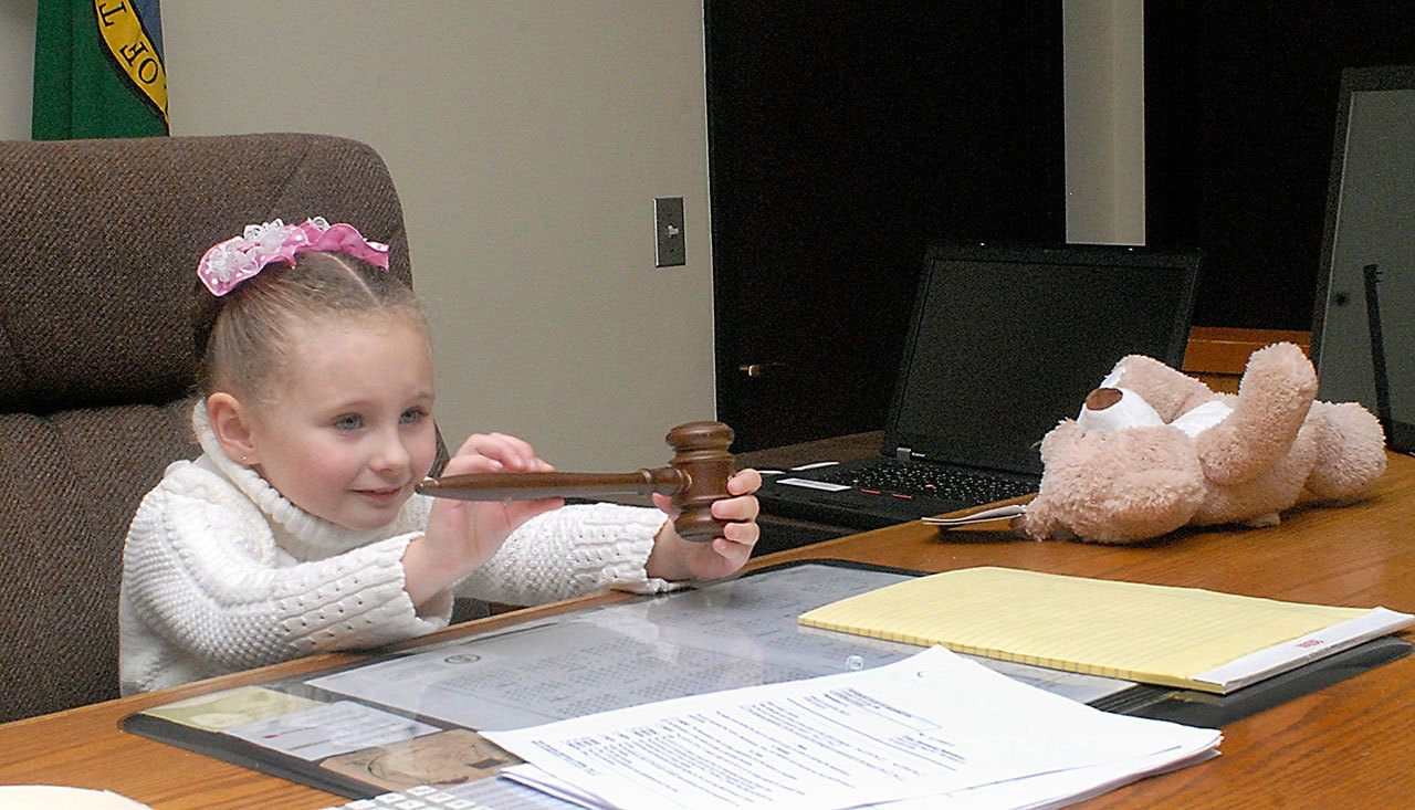 Four-year-old Berit Anala Knight-Porter-Walter plays with a gavel belonging to Clallam County Superior Court Commissioner Brent Basden prior to a court proceeding to officially award her to adoptive mother Debby Walter of Port Angeles on Thursday in Port Angeles. (Keith Thorpe/Peninsula Daily News)