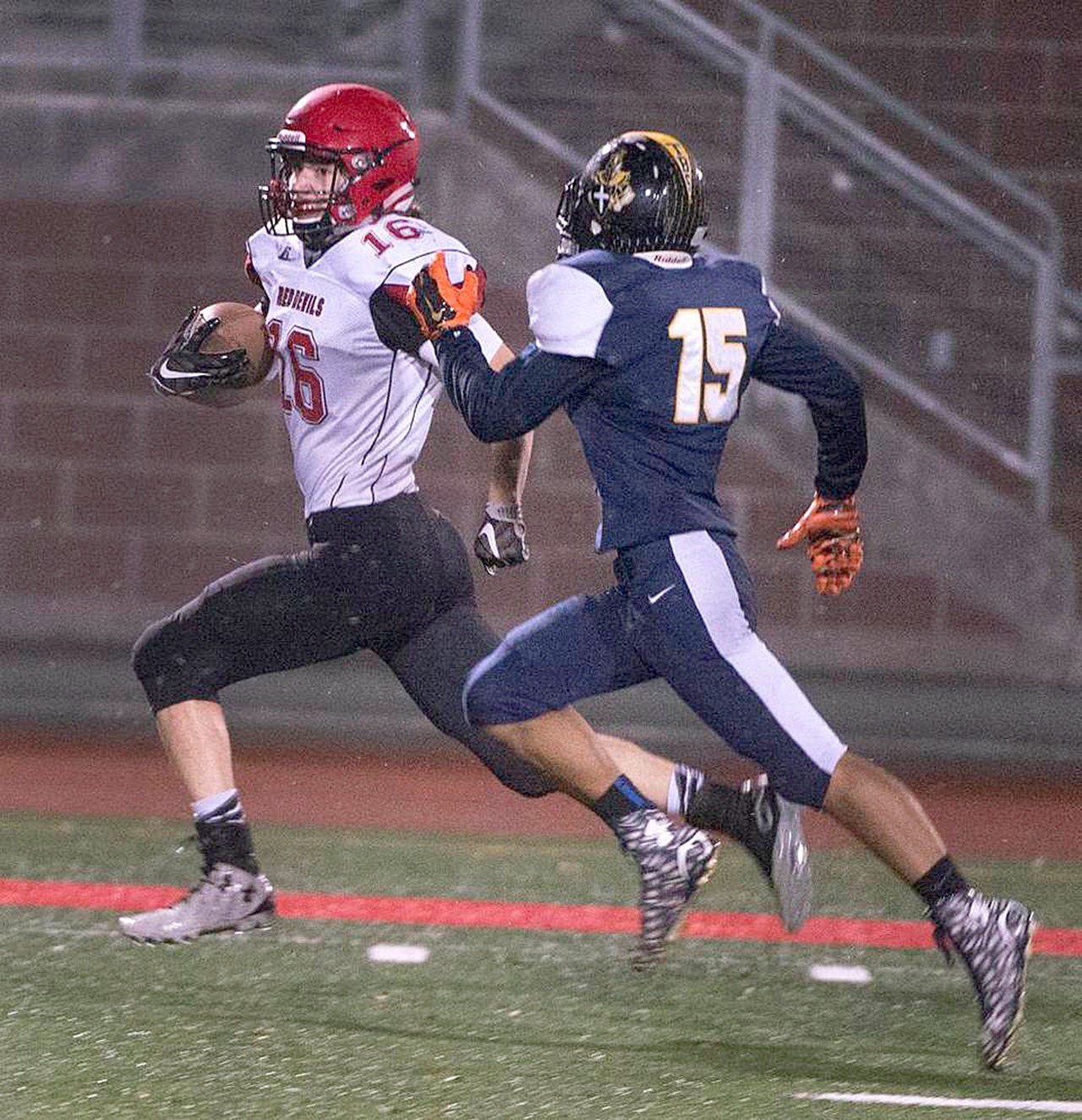 McClatchy News Service Neah Bay’s Cole Svec rips off a long gain as Tacoma Baptist’s Dalen Wilber pursues during the Red Devils’ 66-26 Class 1B state quarterfinal win over the Crusaders. Svec ran for 202 yards on just eight carries.