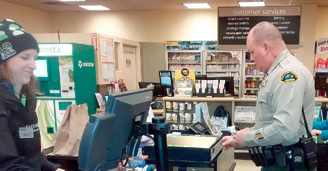 Clallam County Sheriff’s Deputy Don Kitchen buys some groceries for an Army veteran after encountering the man during an “erratic driver” call in the Sequim area.