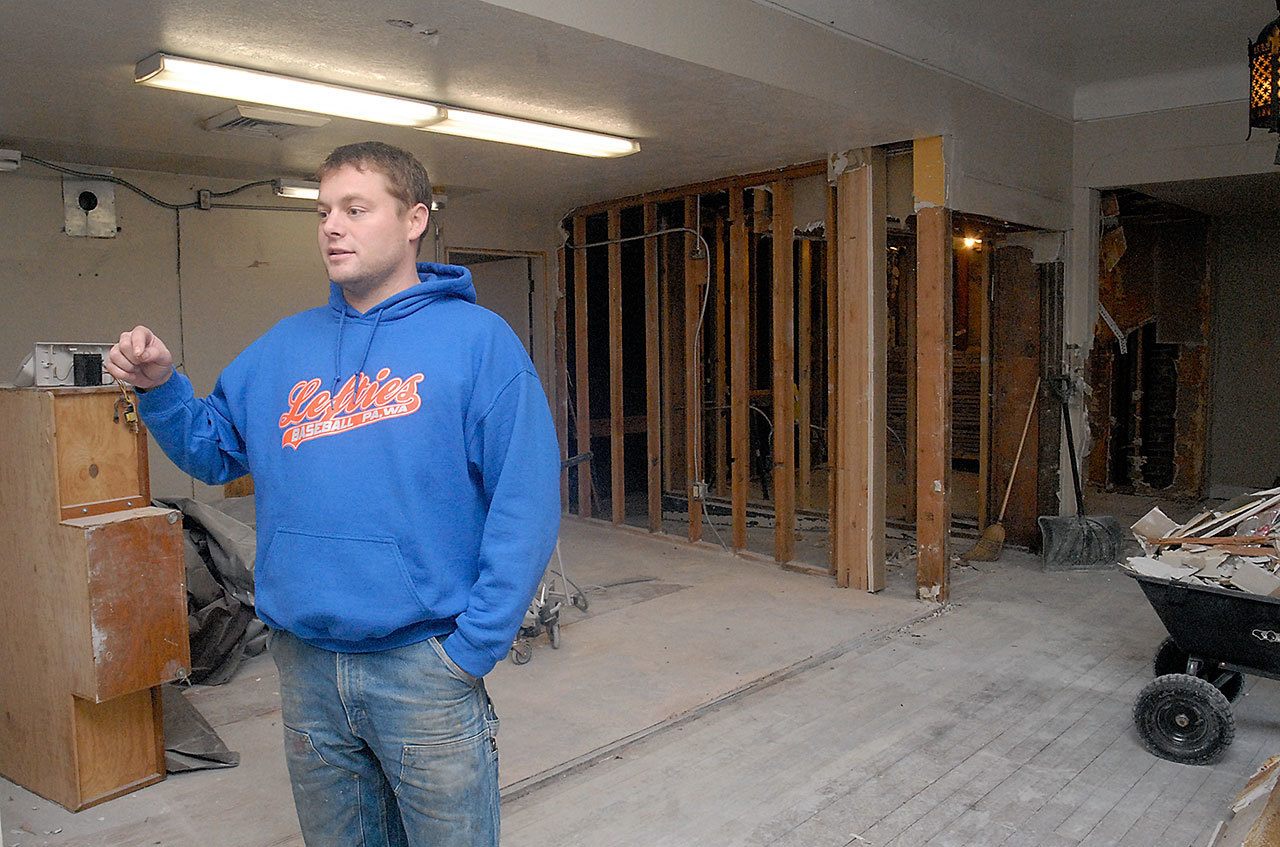 Lincoln Theater owner Jacob Oppelt stands in what was once the concession stand of the former moviehouse during a tour of the building Friday. (Keith Thorpe/Peninsula Daily News)
