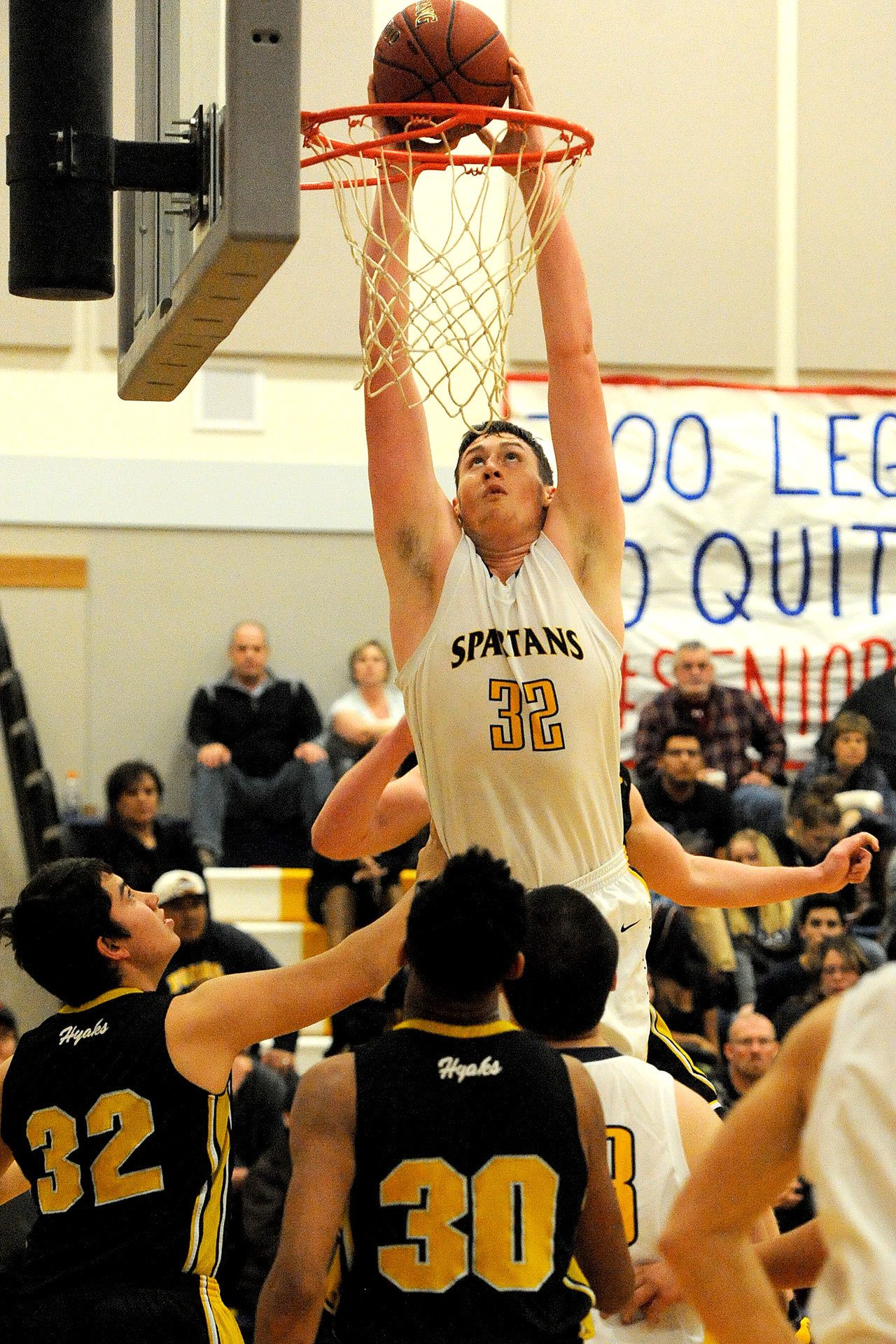Lonnie Archibald/for Peninsula Daily News                                Forks’ Marky Adams (32) dunks over North Beach defenders in the Spartans’ 66-58 non-league win Tuesday.