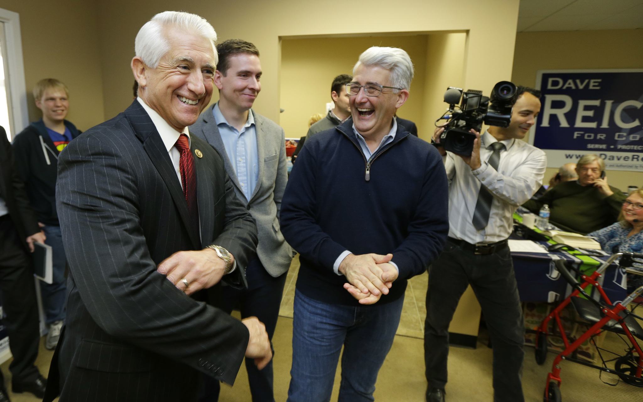 Bill Bryant, center, the Republican candidate for Washington state governor, shares a laugh with U.S. Rep. Dave Reichert, D-Wash., left, following a get-out-the-vote rally Friday at a campaign office in Issaquah. (Ted S. Warren/The Associated Press)