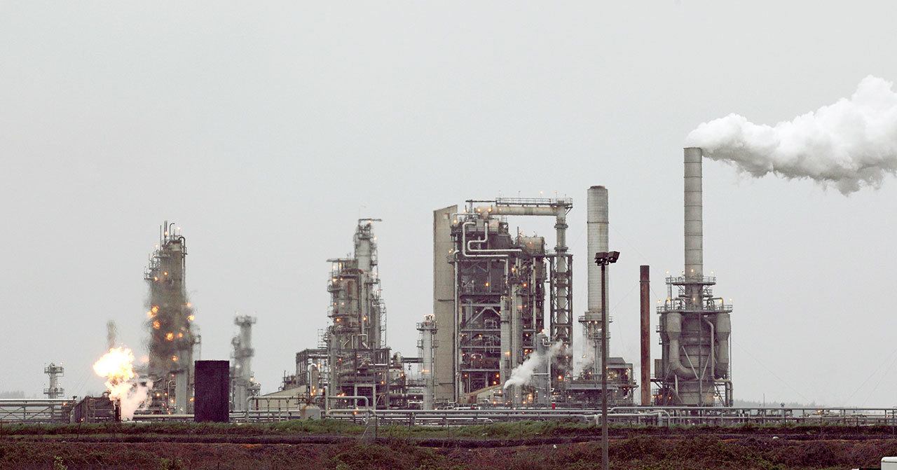 This April 2, 2010, photo shows a Tesoro Corp. refinery, including a gas flare flame that is part of normal plant operations, in Anacortes. (Ted S. Warren/The Associated Press)