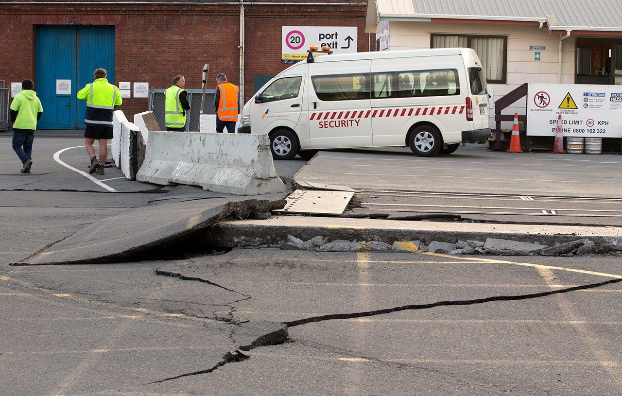 A paved road was lifted and cracked today in Wellington, New Zealand, during an earthquake. A powerful earthquake struck New Zealand’s South Island early today, killing at least two people, causing damage to buildings and infrastructure, and prompting emergency services to warn people along the coast to move to higher ground to avoid tsunami waves. (Mark Mitchell/New Zealand Herald via AP)