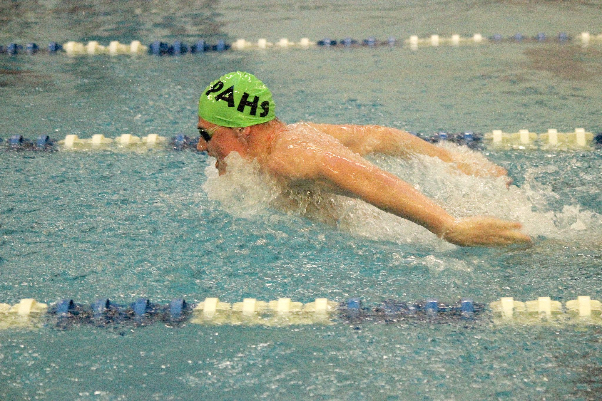 Patty Reifenstahl/for the Peninsula Daily News                                Port Angeles’ Tristin Butler competes in the 100-yard butterfly against Olympic High on Thursday.