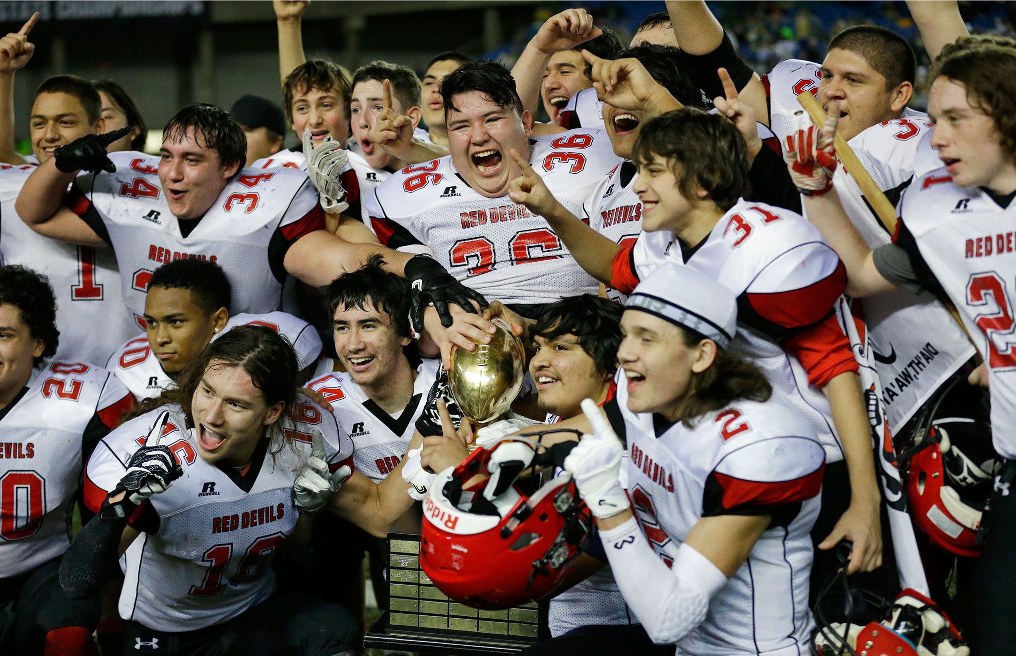 Associated Press                                Neah Bay players, including Matt Reamer (36) yell as they celebrate with the trophy after they beat Odessa-Harrington 64-34 in the Washington Div. 1B high school football championship Saturday at the Tacoma Dome.