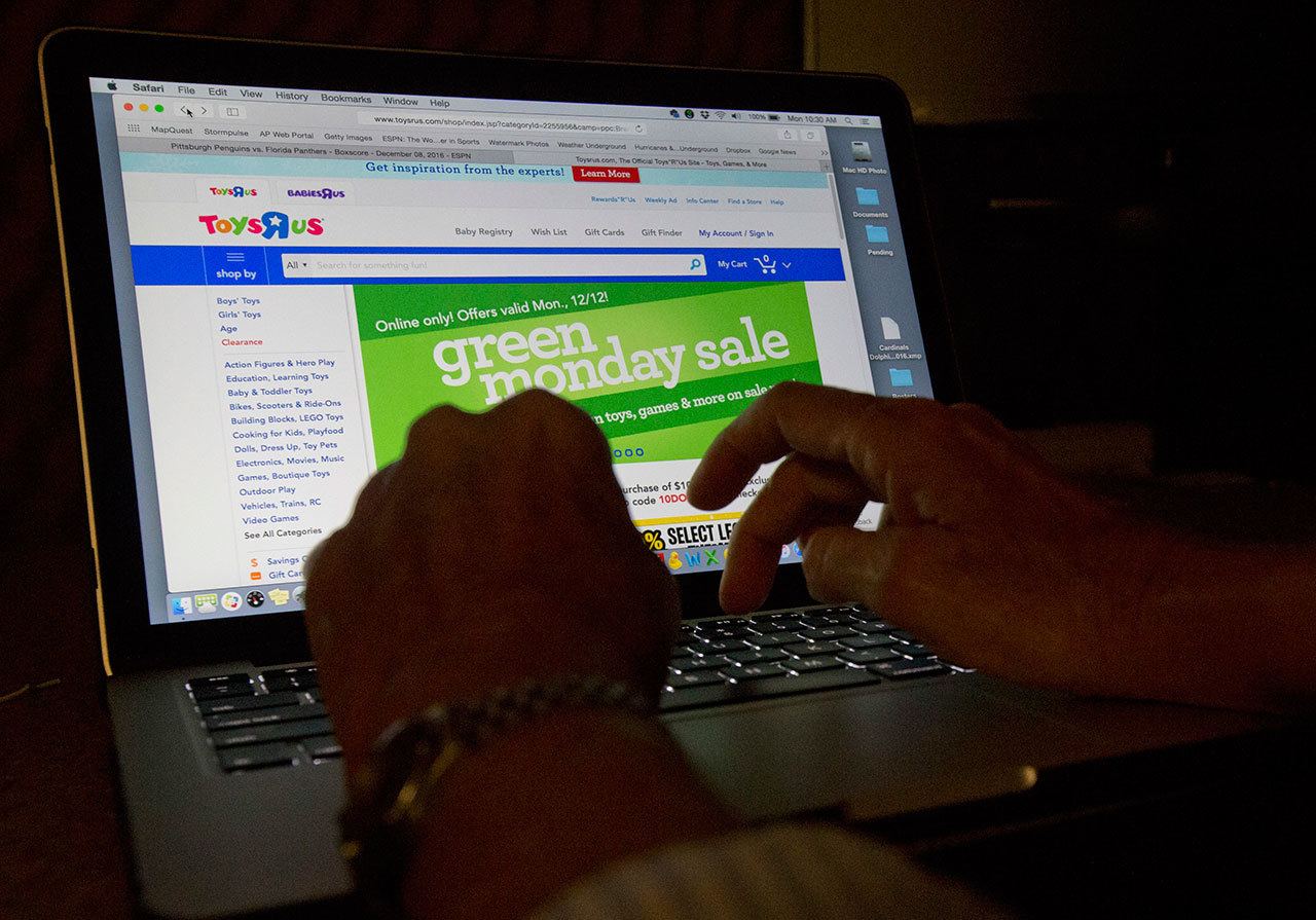 An online shopper searches different sites Monday from Miami. (The Associated Press)