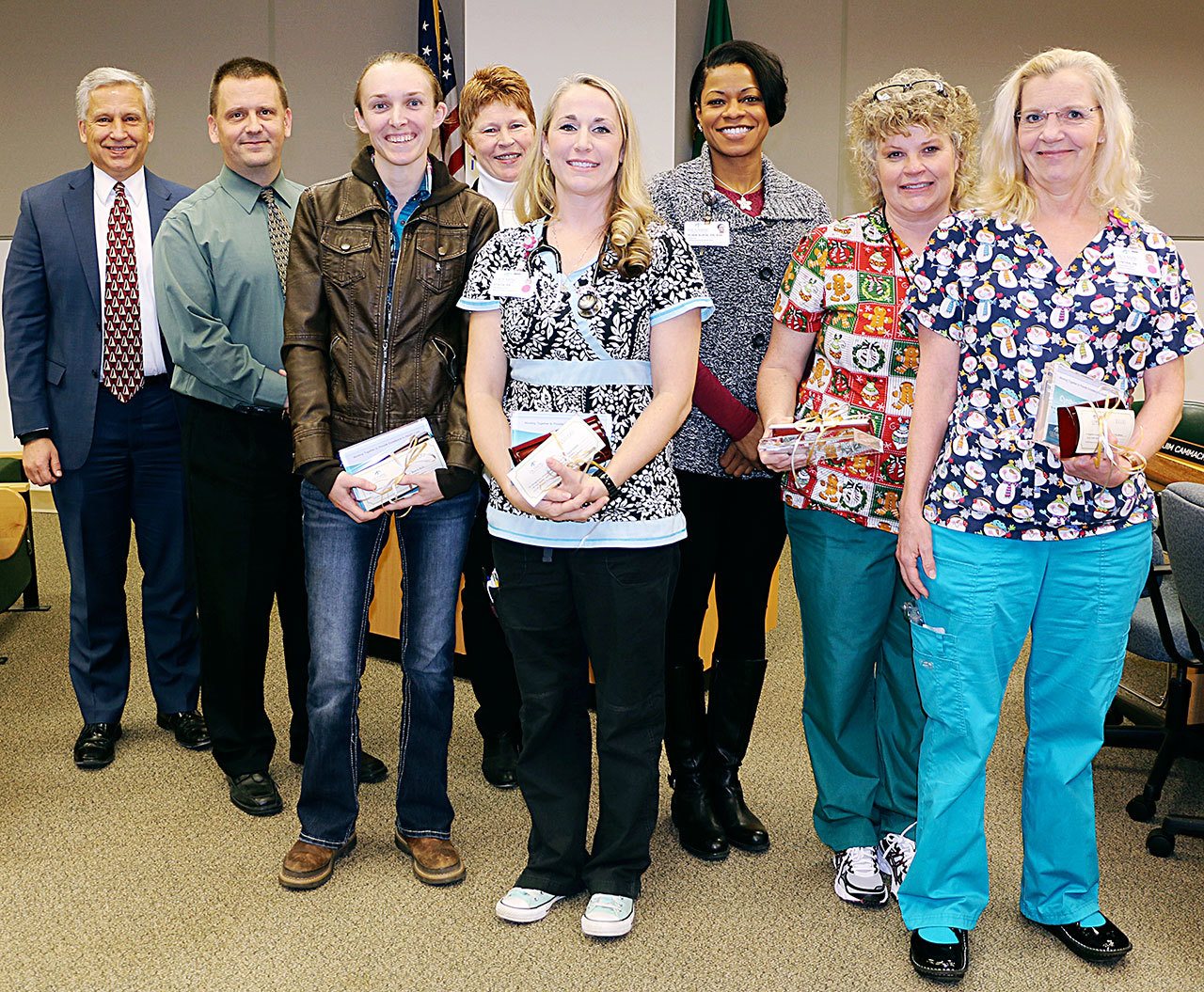 In front row, from left, are Olympic Medical Center employees Beverly Buck, CNA; Stacia Kiesser, RN; Julie Millsap, RN; and Cynthia Beltrami, RN. In back row from left are CEO Eric Lewis; Board President John Nutter; Lorraine Wall, RN, chief nursing officer; and Robin Burse, RN.