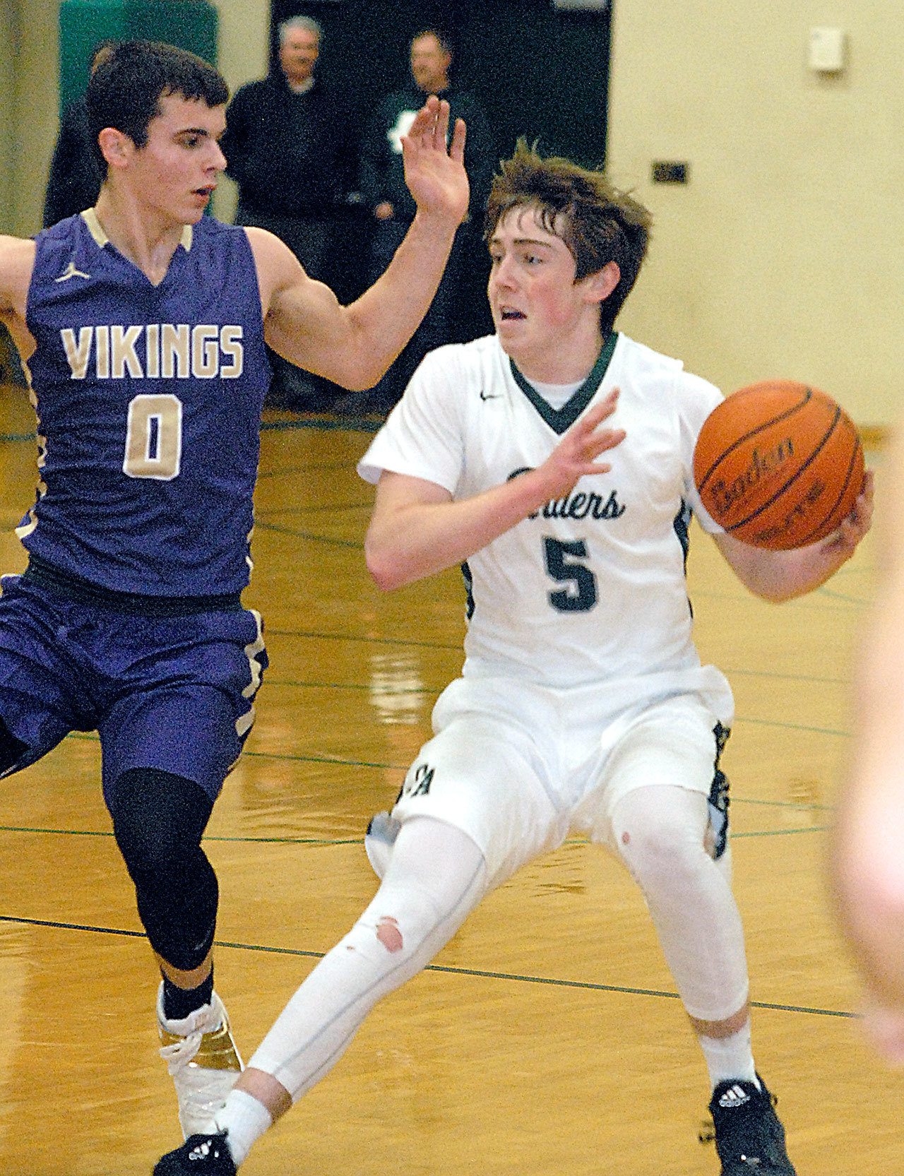Keith Thorpe/Peninsula Daily News Port Angeles’ Noah McGoff, right, looks to pass around North Kitsap’s Zach Olmstead during the Roughriders’ 59-56 loss to the Vikings.