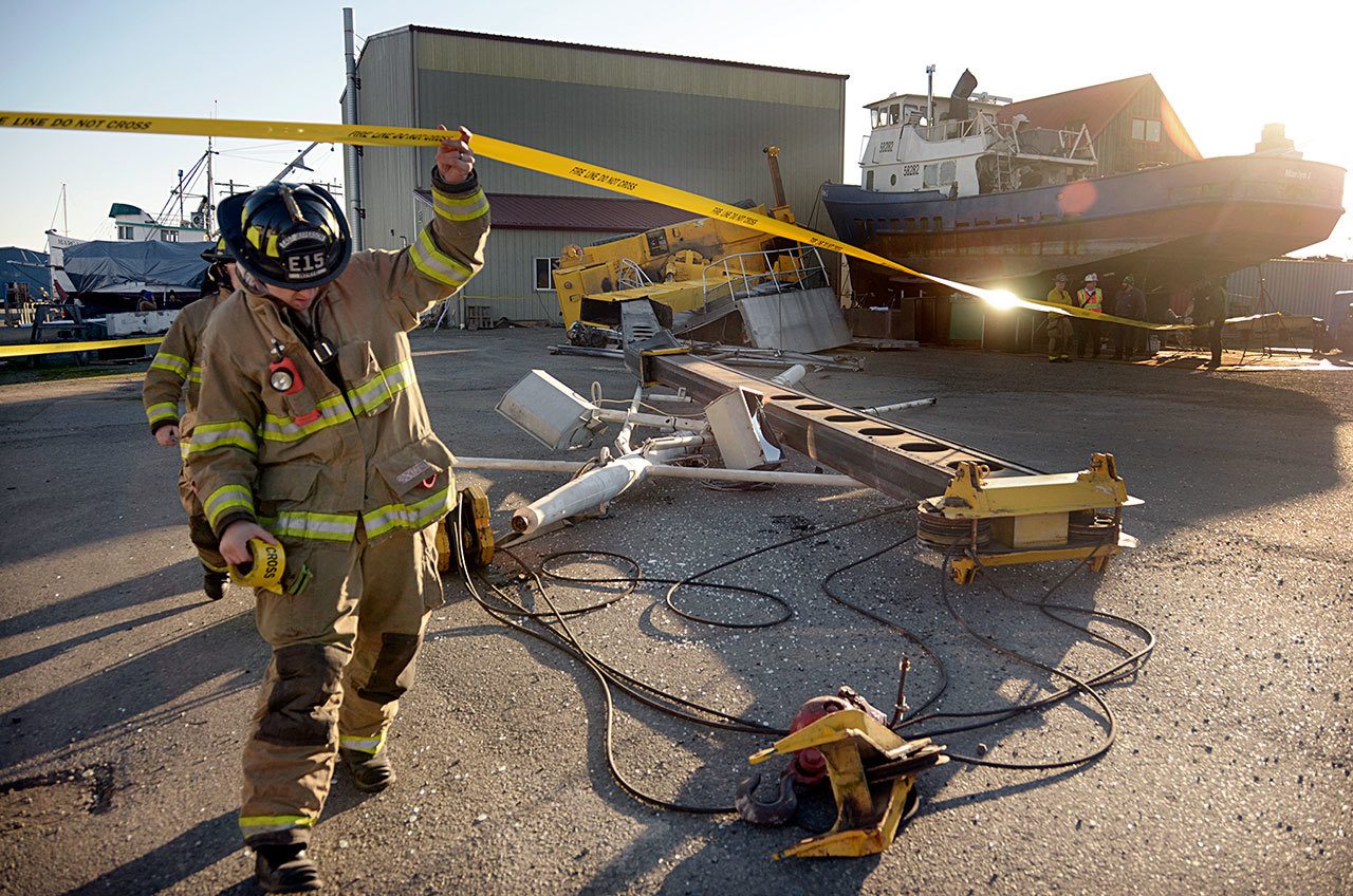 A crane collapsed just after 9:30 a.m. on Friday, injuring and briefly trapping the crane operator. (Cydney McFarland/Peninsula Daily News)