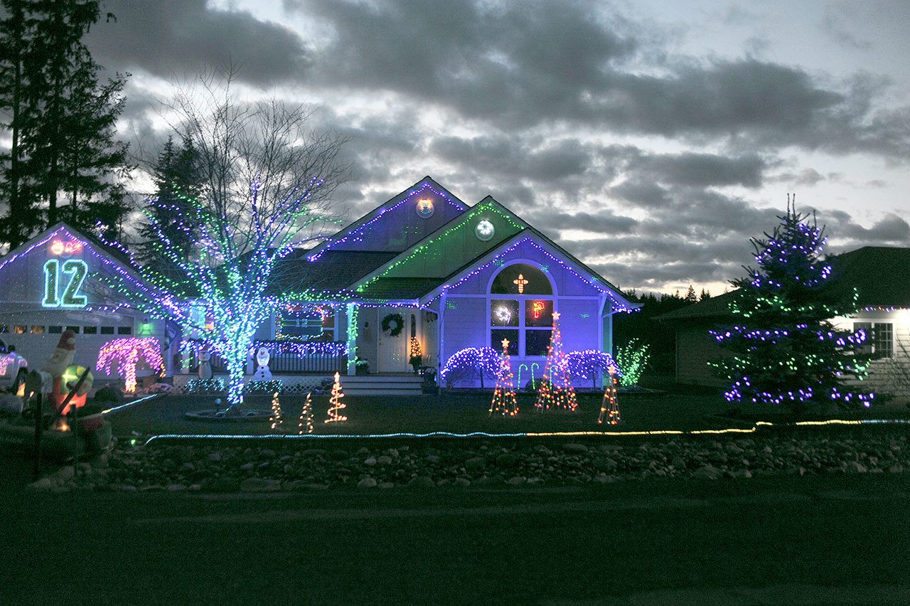 Bob Ball’s home, 650 Klahndike Blvd. in Forks, is decorated in Seattle Seahawks colors with the 12th man displayed on the garage. (Lonnie Archibald/for Peninsula Daily News)