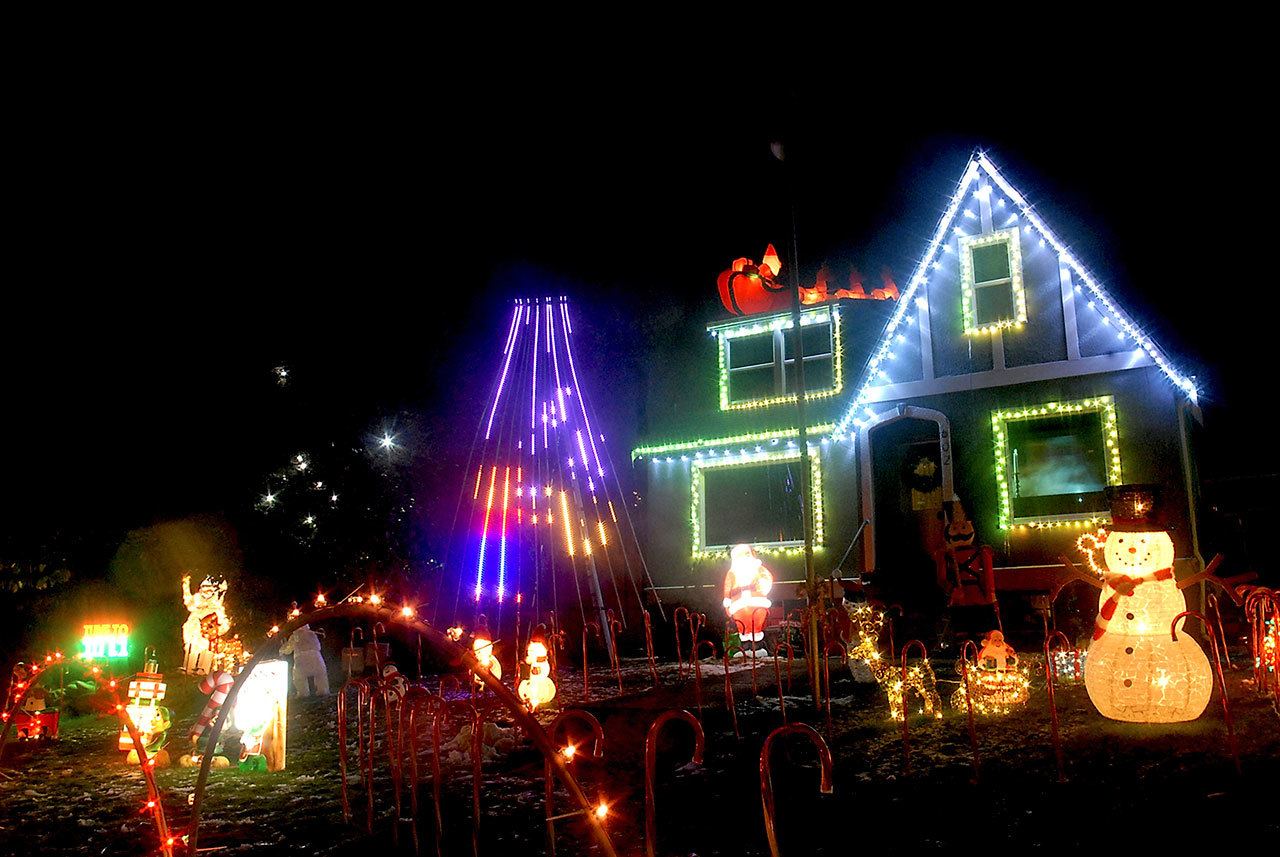 A holiday display with accompanying music available through a car radio graces the front lawn of a home at 602 E. Lauridsen Blvd., in Port Angeles. (Keith Thorpe/Peninsula Daily News)