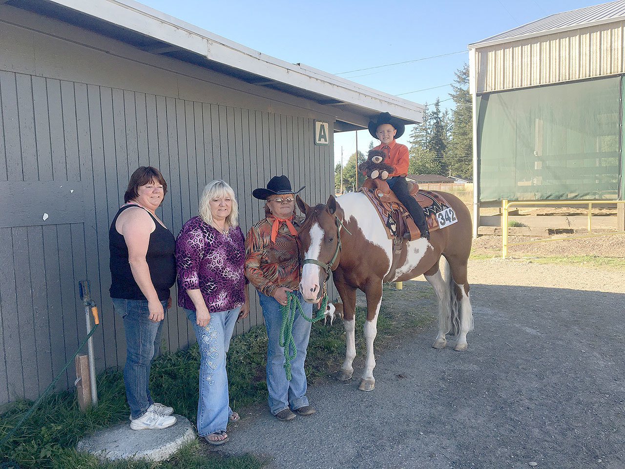 Aidan Bentley Johnstad won this year’s Washington State Horsemen Leadline State Championship. Johnstad comes from a family of WSH top competitors. From left are aunt Lisa Hopper, grandma Terri Winters, aunt Tina Johnson and Aidan sits astride Johnson’s horse Reba. (Tim Johnson)
