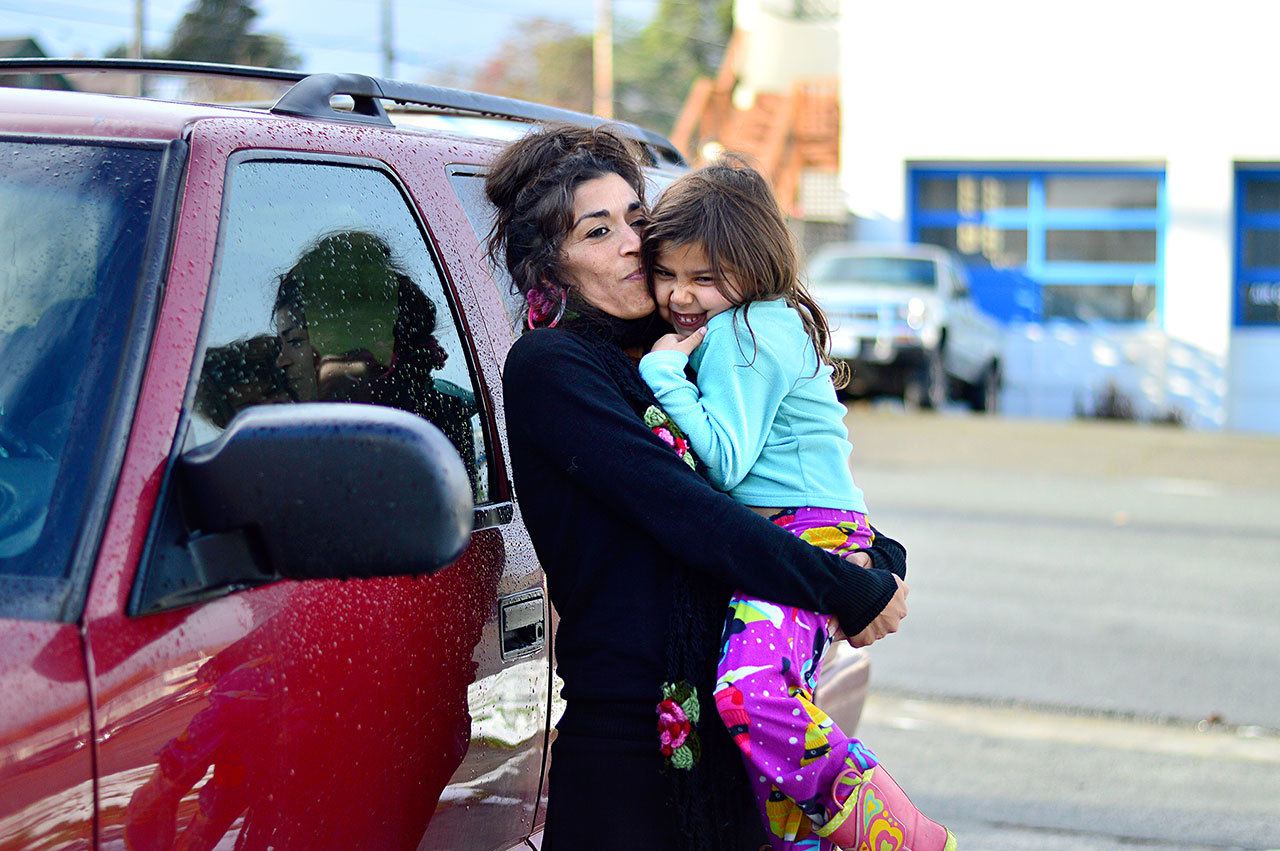 Amilalupe Aguilar and her daughter Macha, 5, reunite with their Chevy Blazer following extensive repairs done at Peninsula College’s auto shop. (Diane Urbani de la Paz/for Peninsula Daily News)