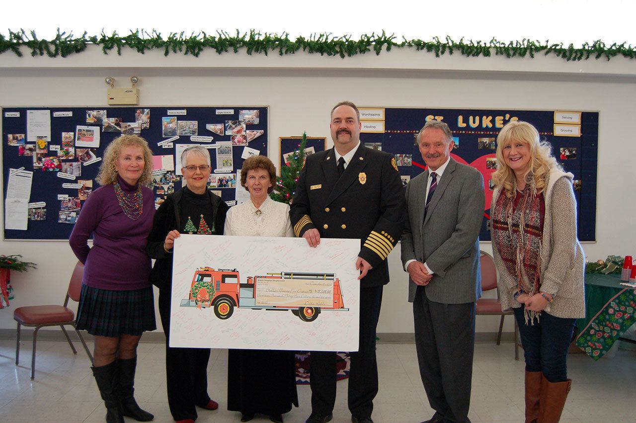 From left are Sequim-Dungeness Hospital Guild President Jean Janis, Sequim-Dungeness Hospital Guild Secretary Jan Keithly and thrift shop board Secretary Connie Hixson, presenting a $17,039 check to Fire District 3 Chief Ben Andrews, Fire Commissioner James Barnfather and Fire District 3 secretary Pattie Williams.