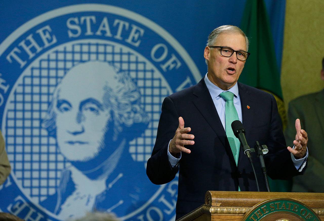 Gov. Jay Inslee talks to reporters about his proposed budget in Olympia last Friday. Inslee will try to convince lawmakers to do something voters wouldn’t last month: approve a new tax on carbon emissions from fossil fuels. (Ted S. Warren/Associated Press)