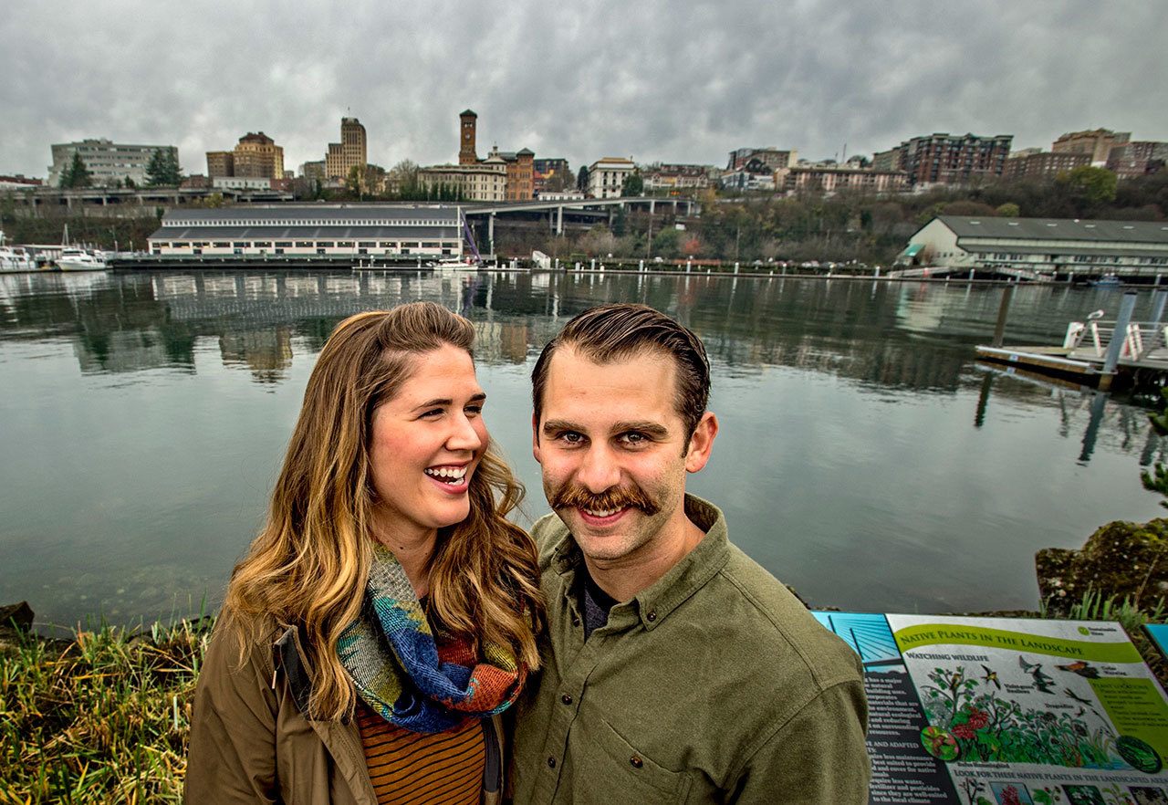 Gig Harbor sweethearts Mattie and Jake Harrison pose for a photo along the Thea Foss waterway in Tacoma last month. (David Montesino/The News Tribune via AP)