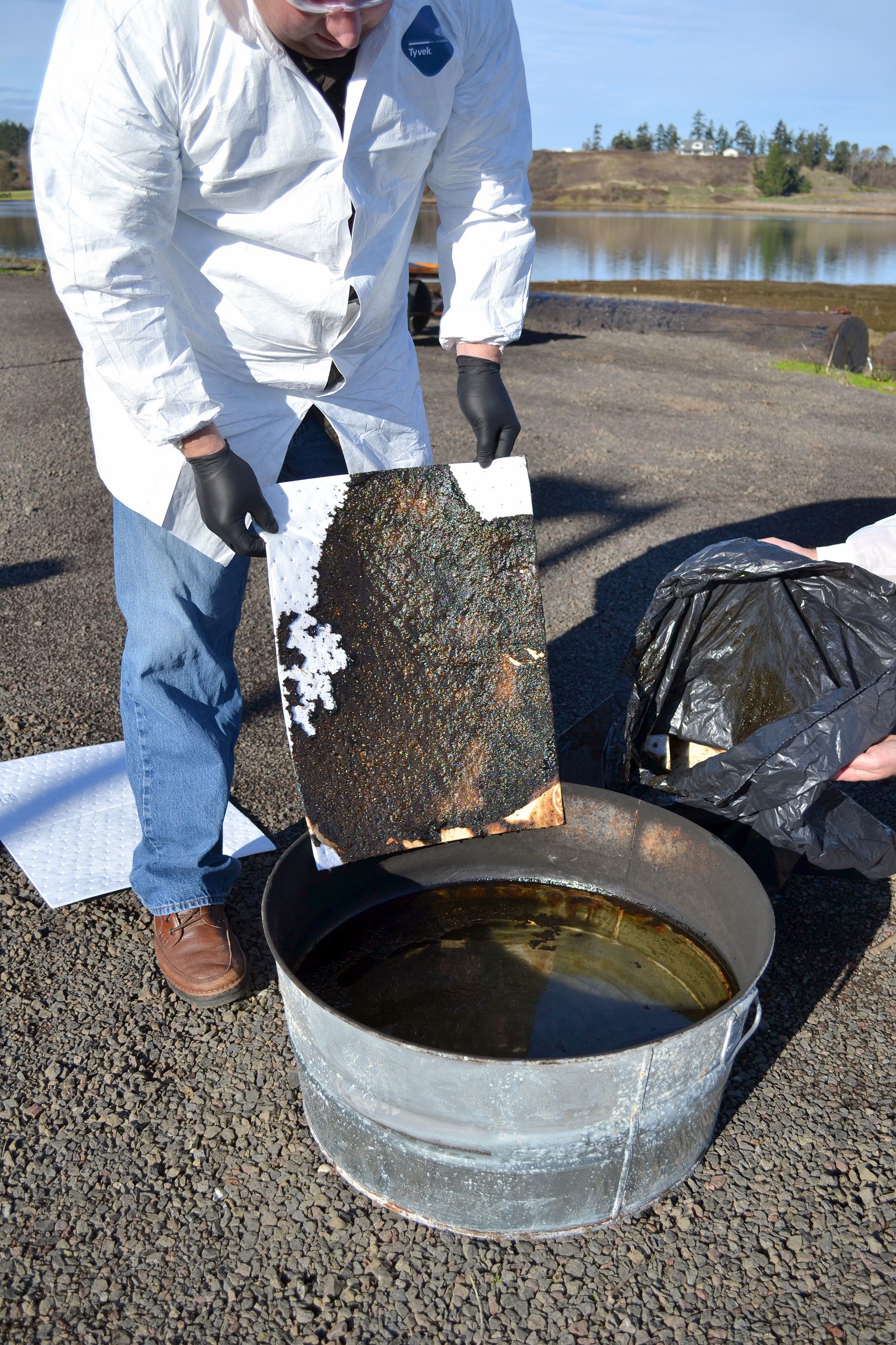 These absorbent pads measure how much oil is left over after it’s burned using a wood product scientists created with wood shavings. Their goal is to burn at least 90 percent of the oil of the water. (Matthew Nash/Olympic Peninsula News Group)