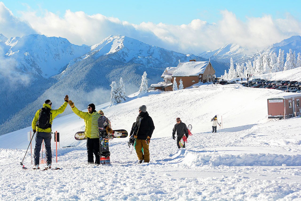 Snowboarders and skiers flock to Hurricane Ridge in this December file photo. (Jesse Major/Peninsula Daily News)