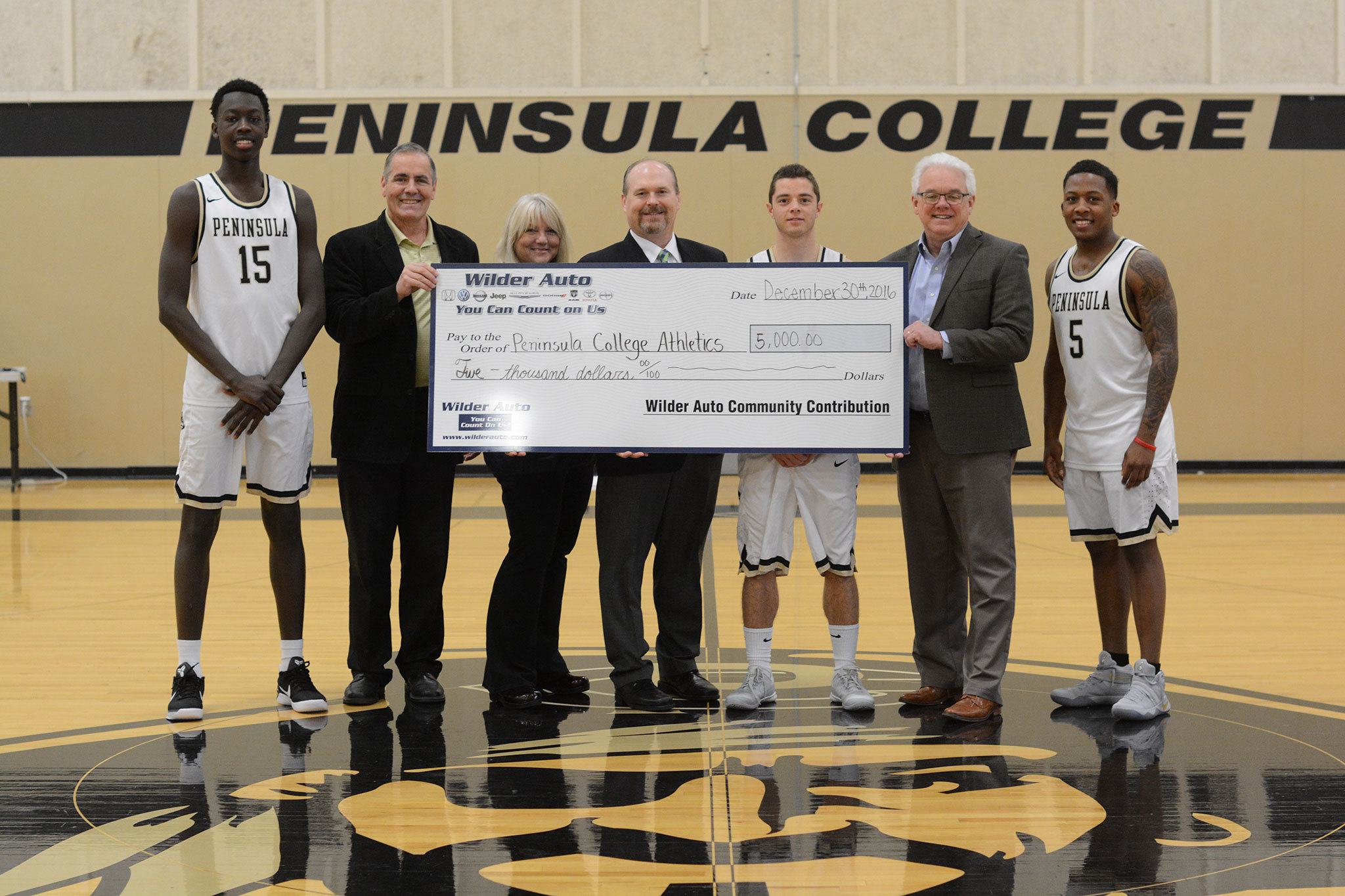 From left are Pirates’ basketball player Omar Lo, Athletic Director Rick Ross, Tami Rose and Dan Wilder Jr. from Wilder Auto, basketball player Jalon McCullough, Peninsula College President Dr. Luke Robins and basketball player Darrion Daniels. The donation to the Pirate Athletic Association will go toward supporting athletic scholarships.