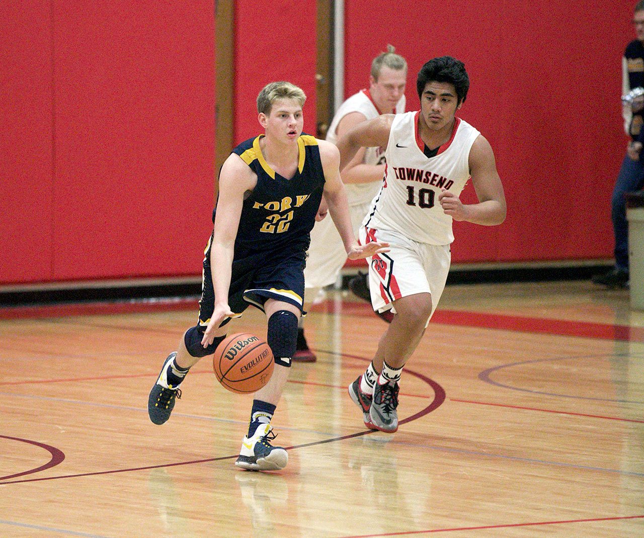 Steve Mullensky/for Peninsula Daily News Forks’ Parker Browning, 22, races Redhawk Detrius Kelsall down court during a Thursday night game in Port Townsend.