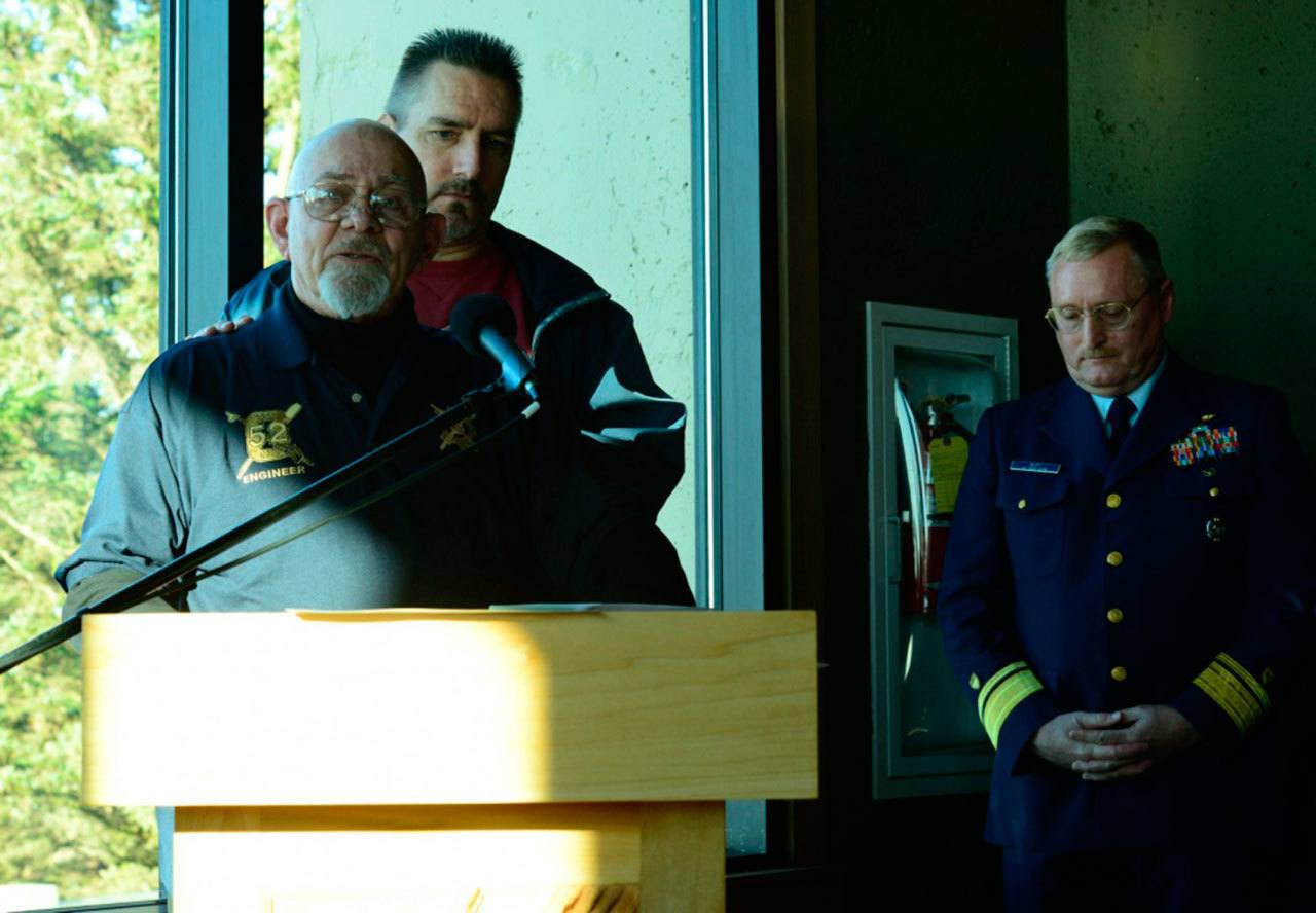 Gordon Huggins and Jeff Rusiecki, both former Coast Guardsmen and honorary guests at a memorial ceremony Saturday, speak about their experiences in surviving tragic accidents involving Coast Guard assets. (Levi Read/U.S. Coast Guard)